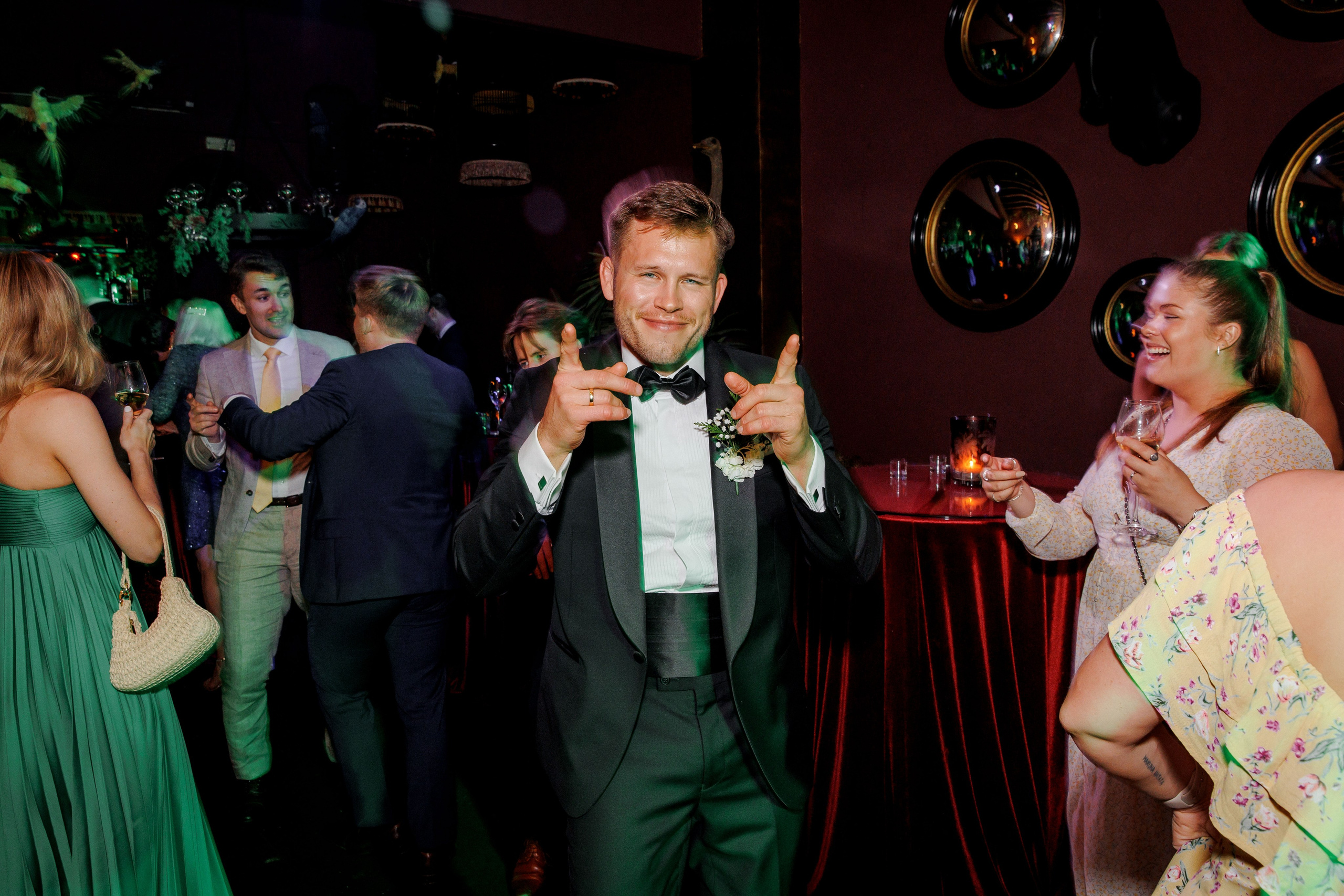 Energetic groom dancing on the dance floor during the wedding party in Barcelona.