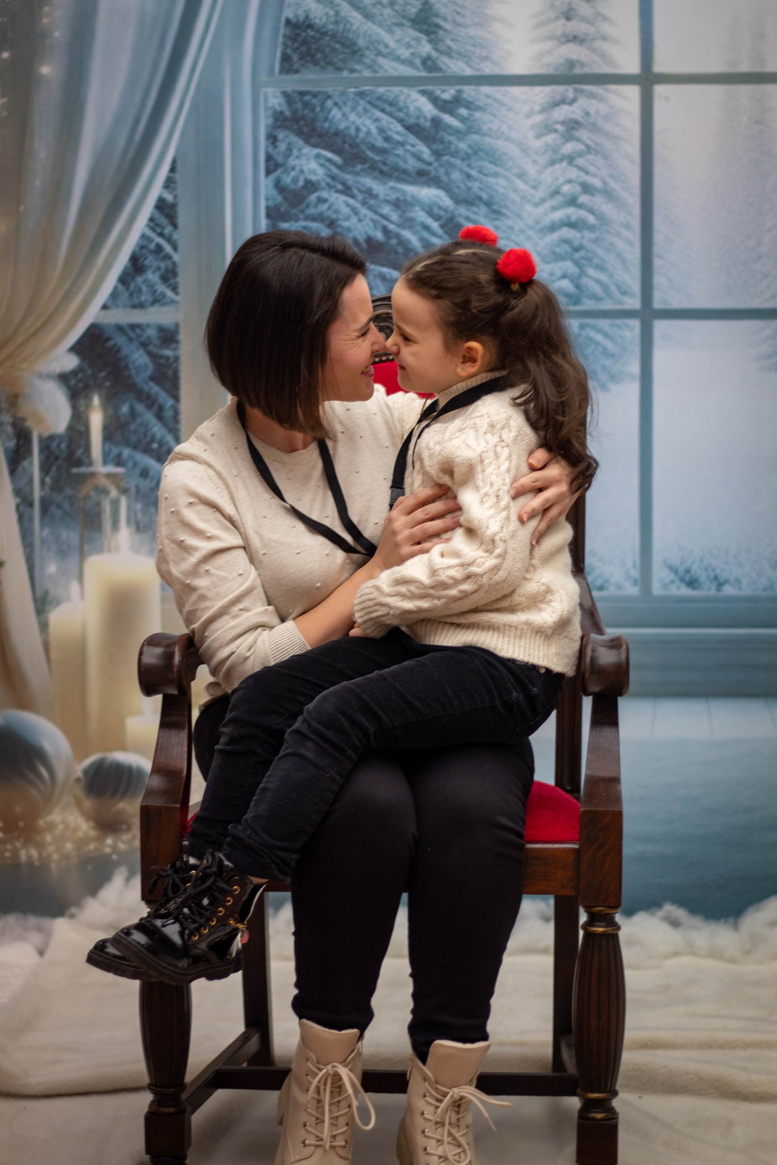 Mother hugging her young daughter on a park bench in bright daylight.