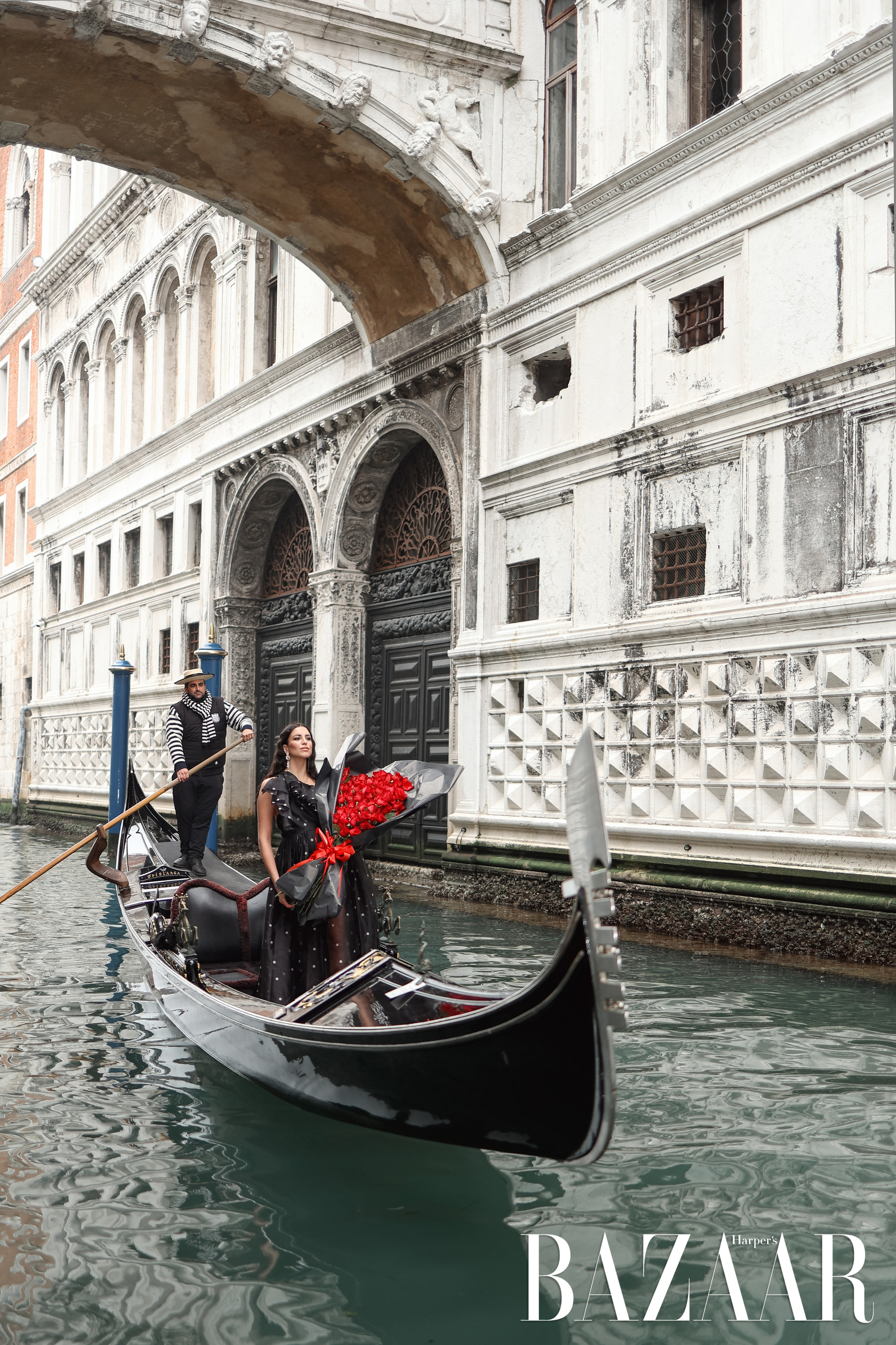 woman with a bouquet of red roses in a gondola