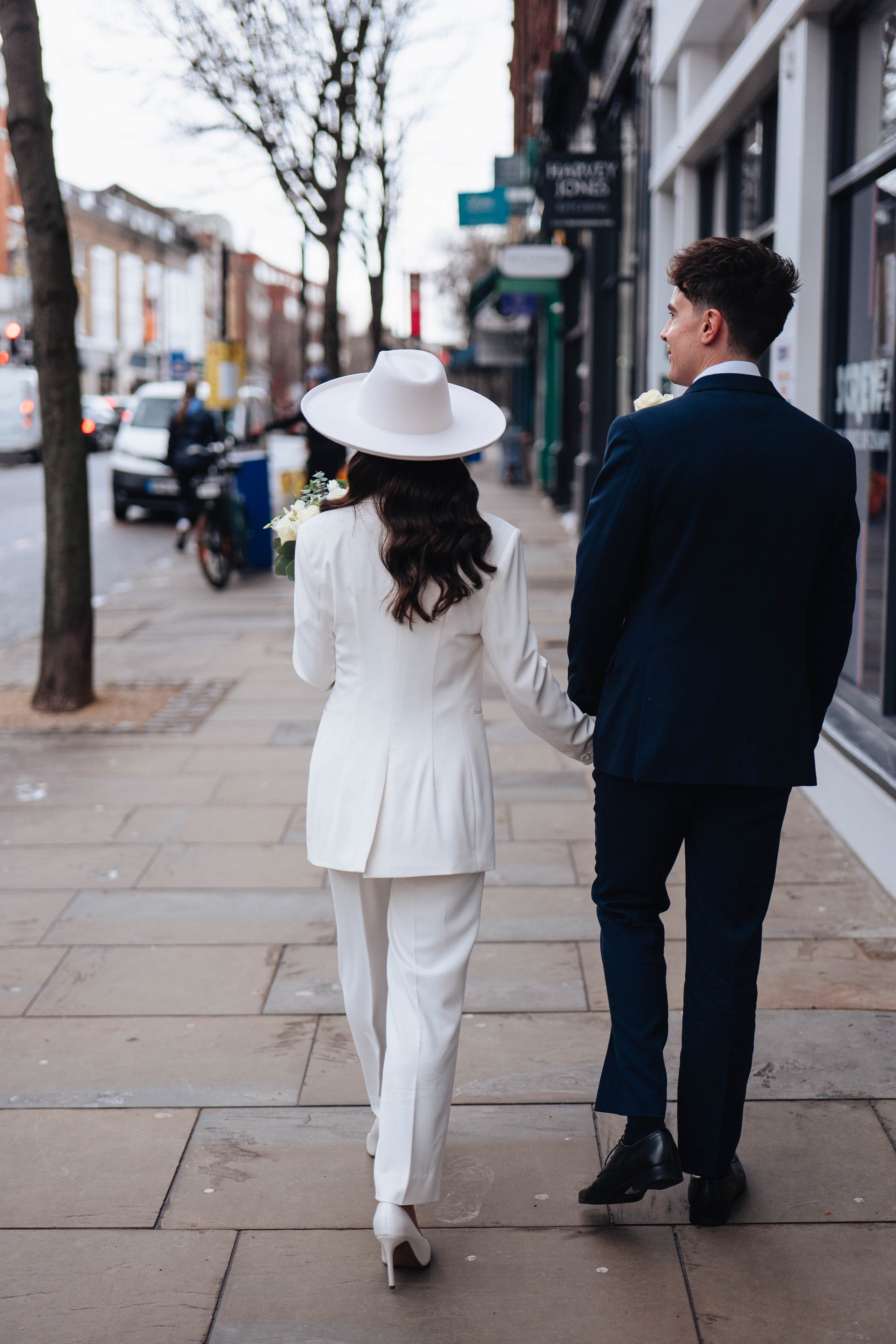 Stylish wedding in Islington, white women costume and white hat