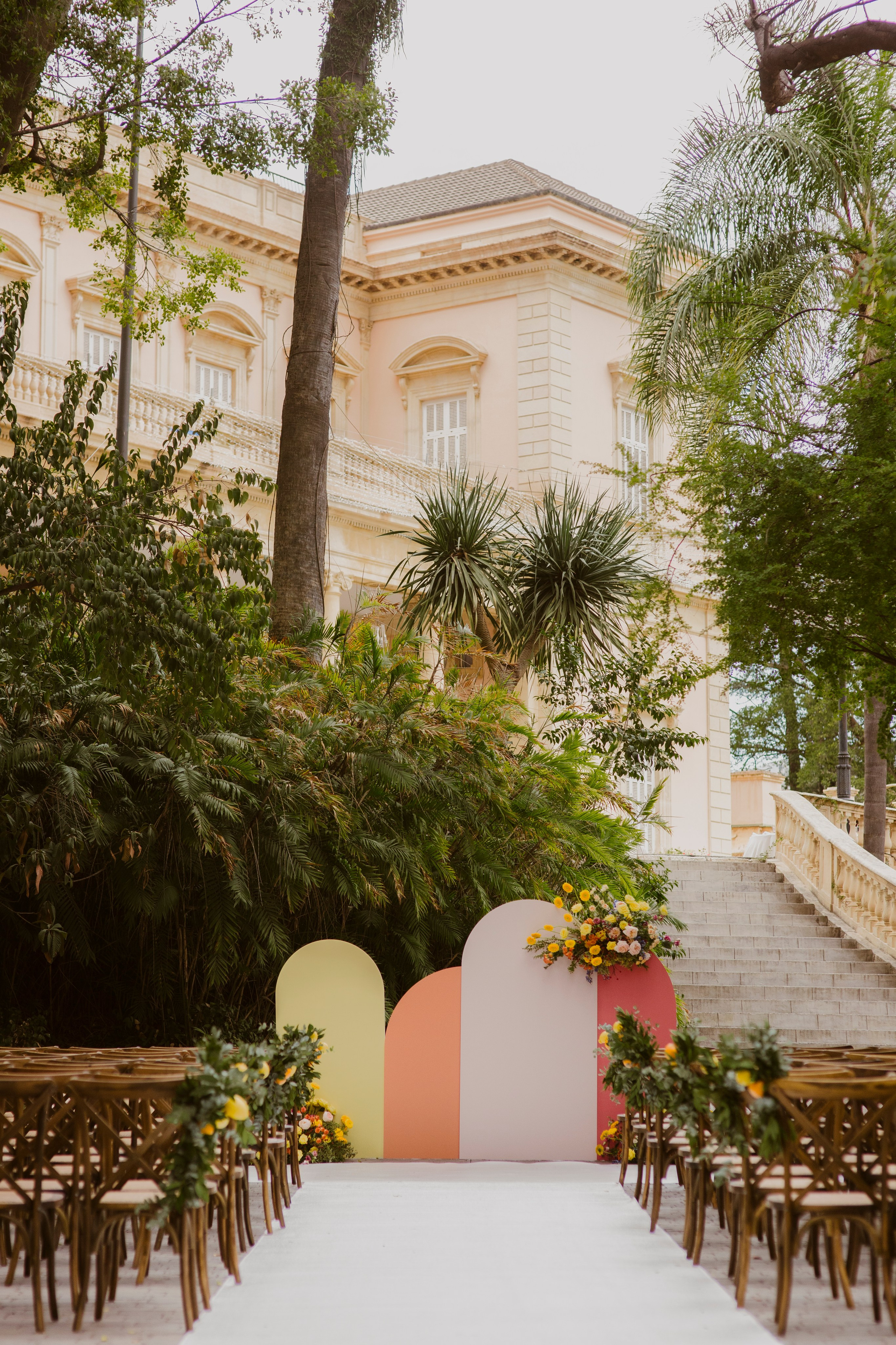 A wedding outside ceremony with chairs at the palace