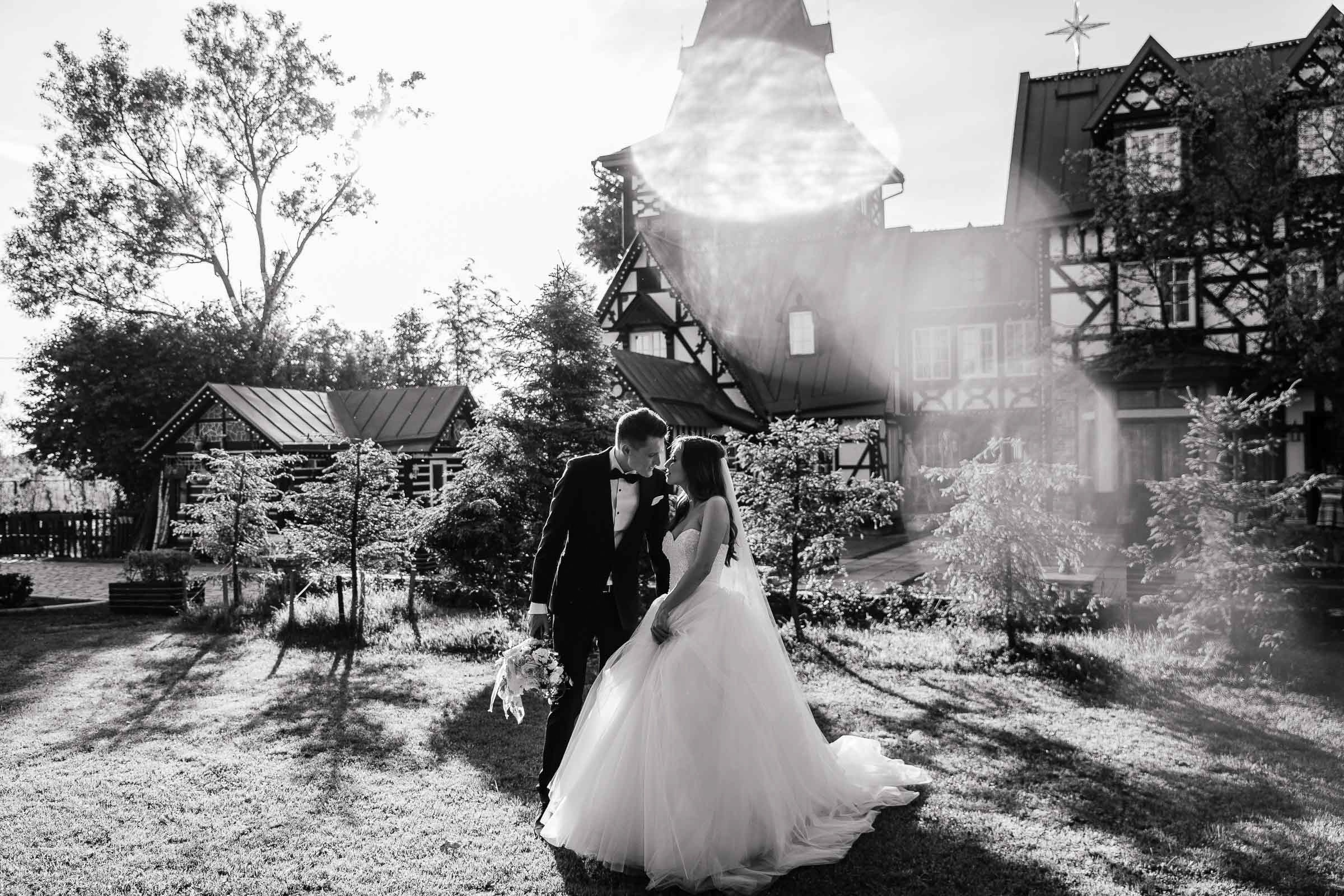 Bride and groom in gardens by grand house, by Tanya Bodgan, St Ives wedding photographer.