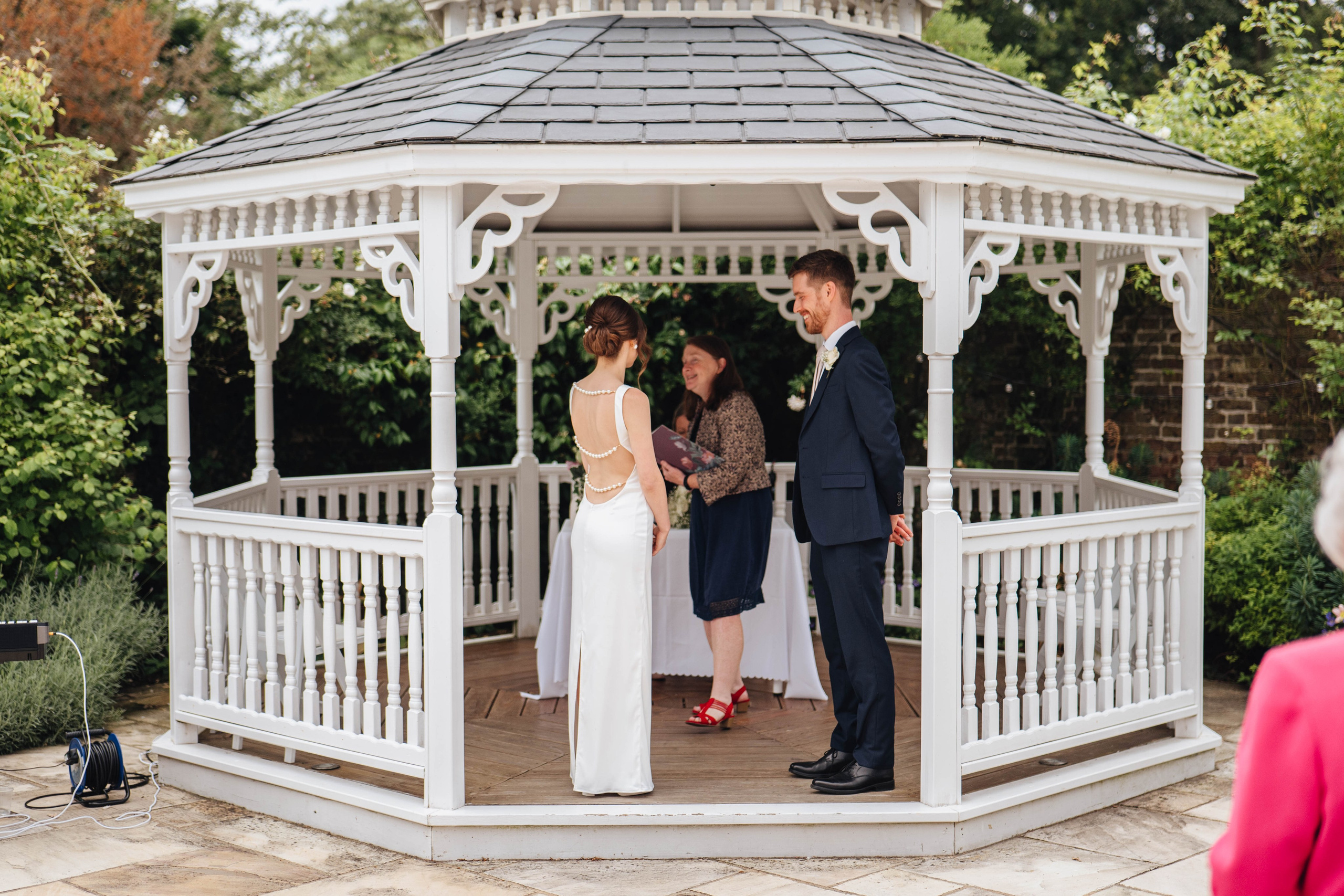 bride and groom at the ceremony, holding hands