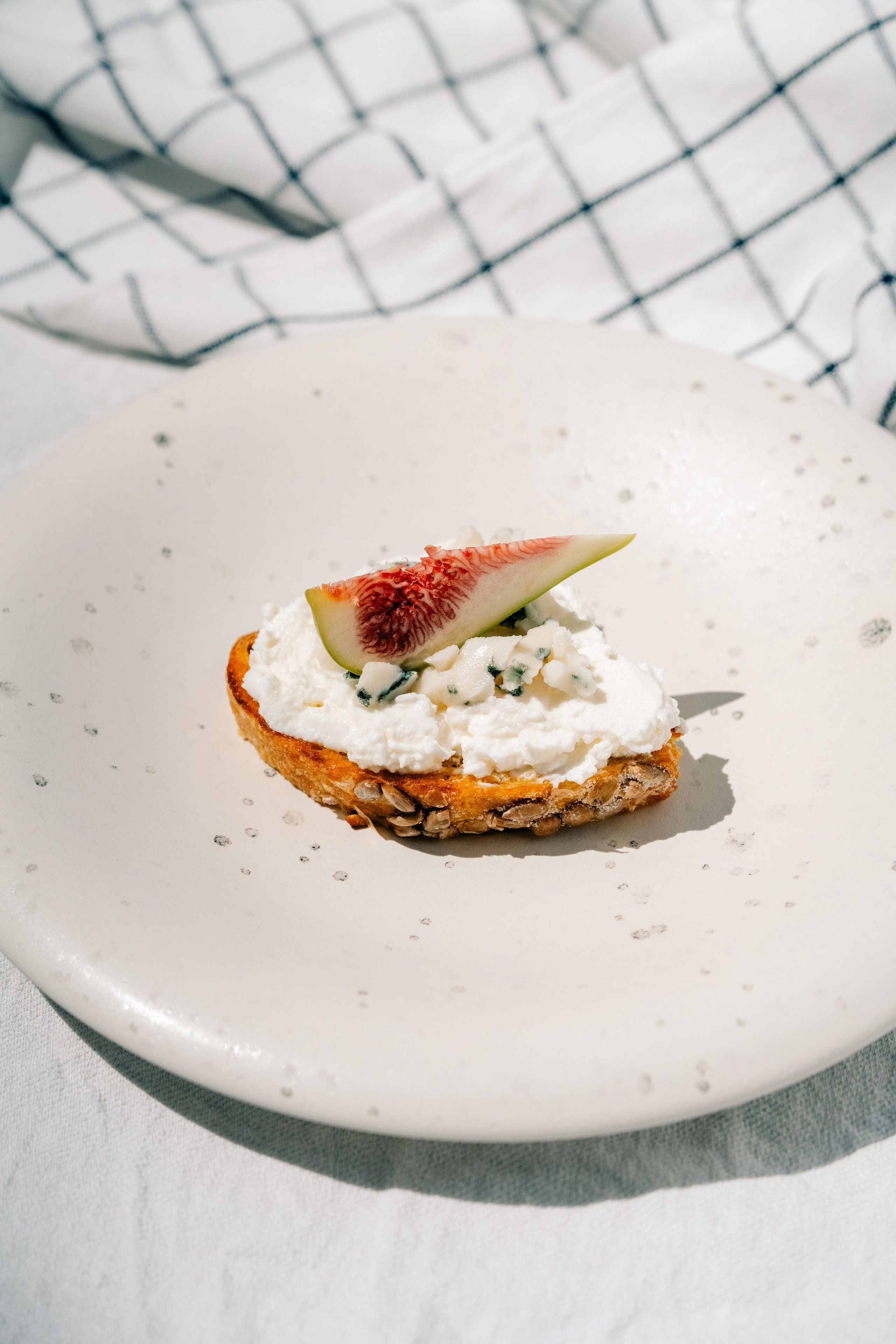 Cheese and fig open sandwich with a honey drop. Maria Sher. Professional photographer from Porto, Portugal