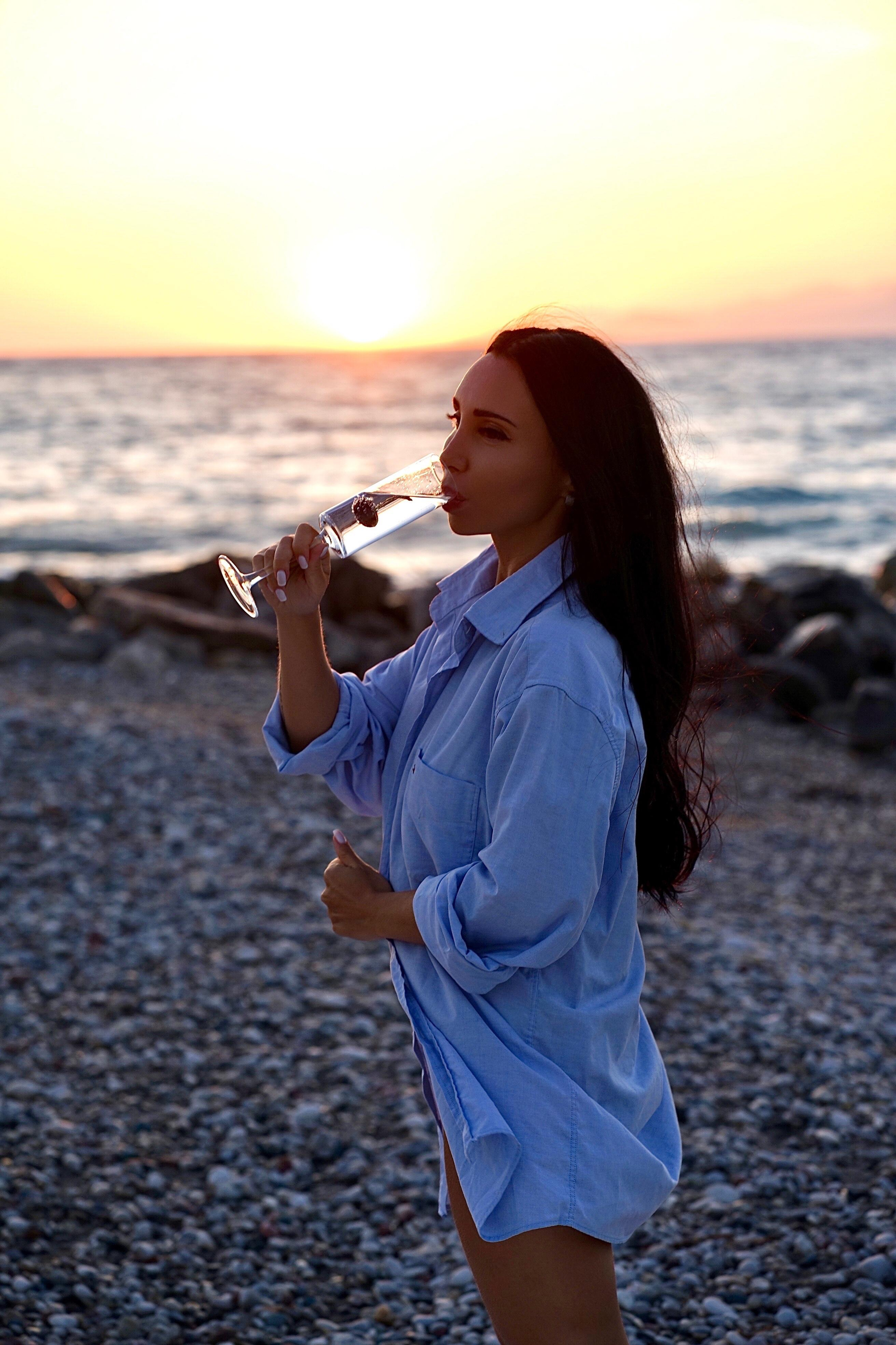 Sunset with beautiful Zenia. Photographer at Santorini