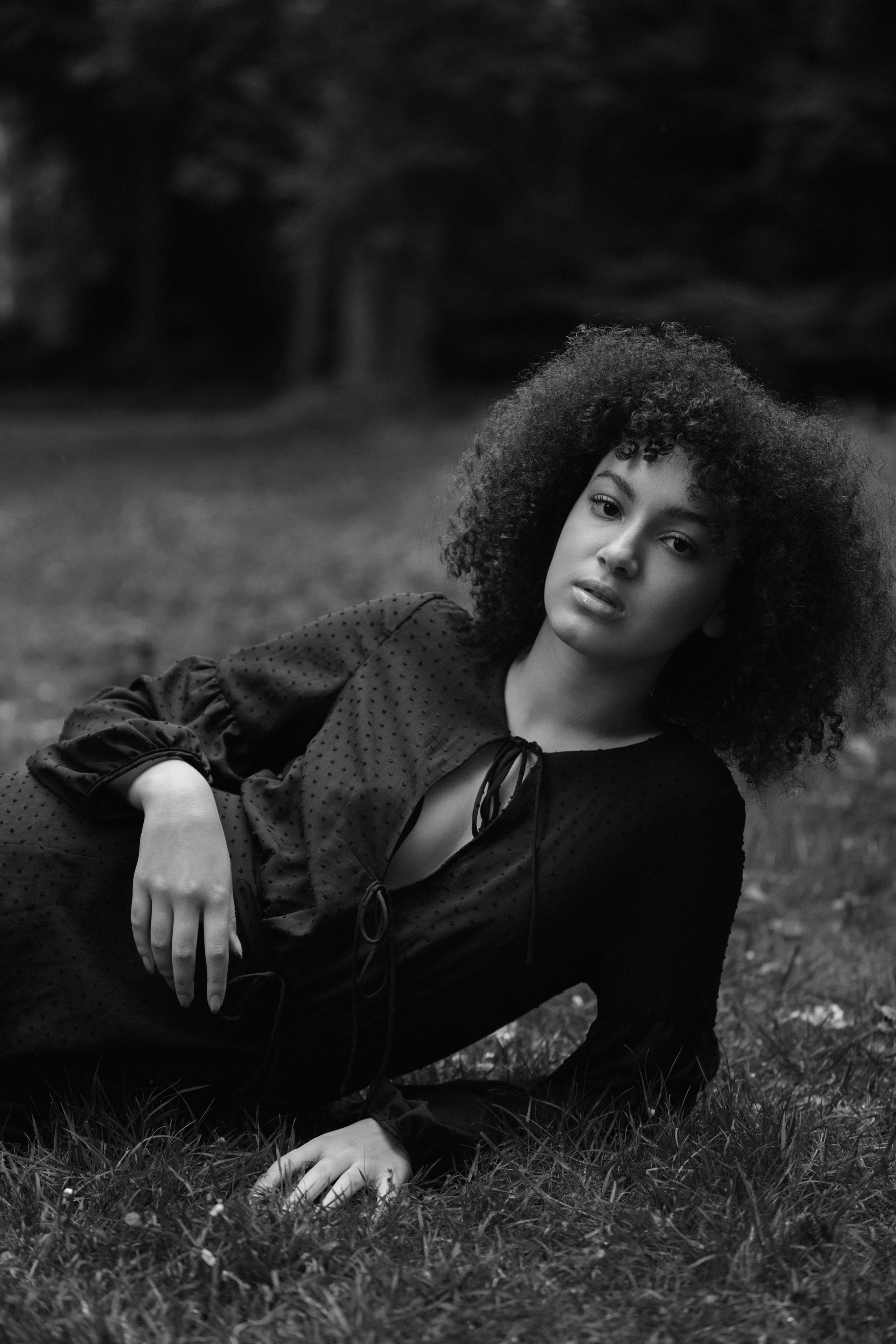 Outdoor portrait, woman reclining in grass, natural light setting