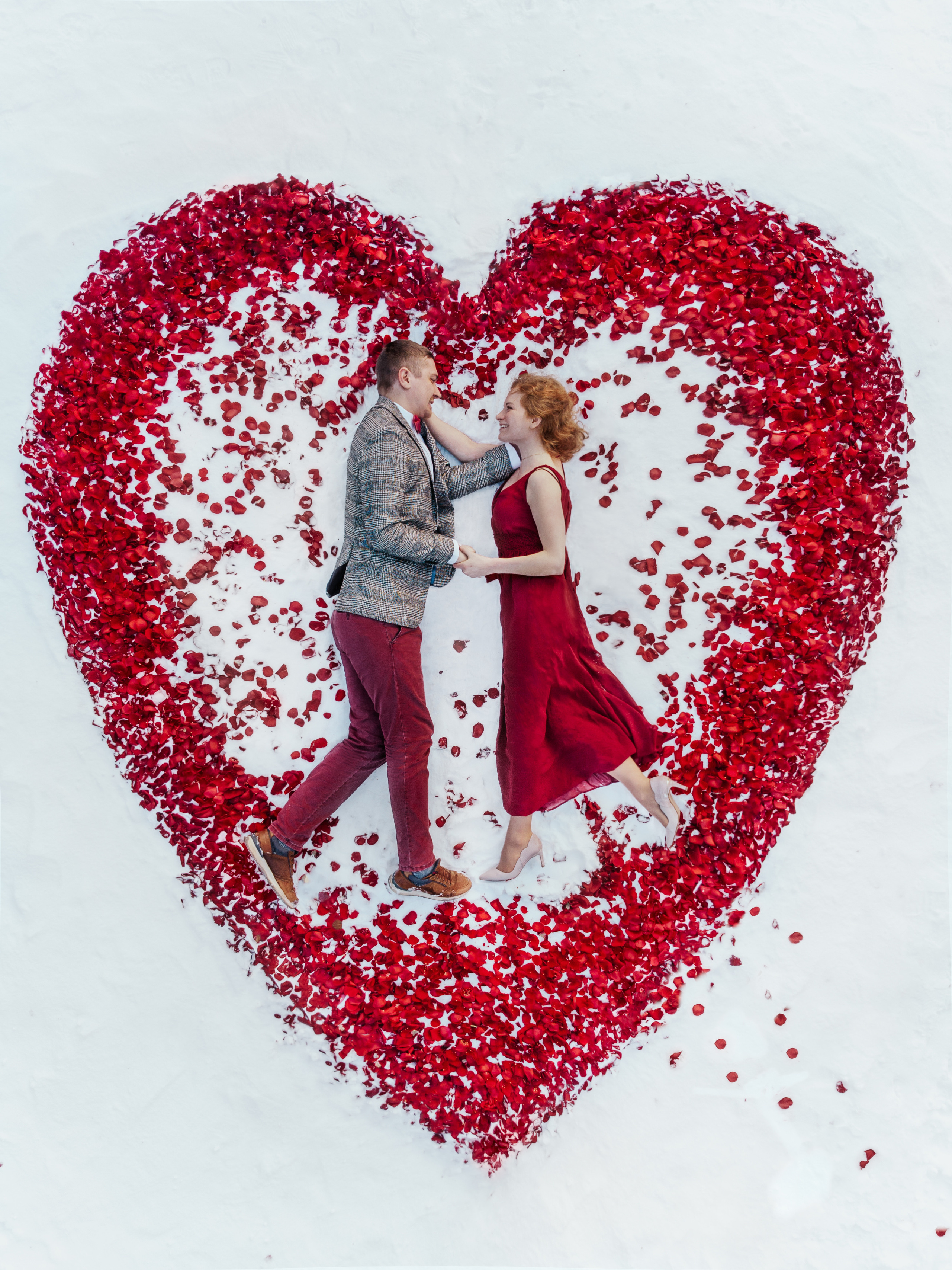 Romantic couple in heart of rose petals - Barcelona brand & beauty photography for social media.