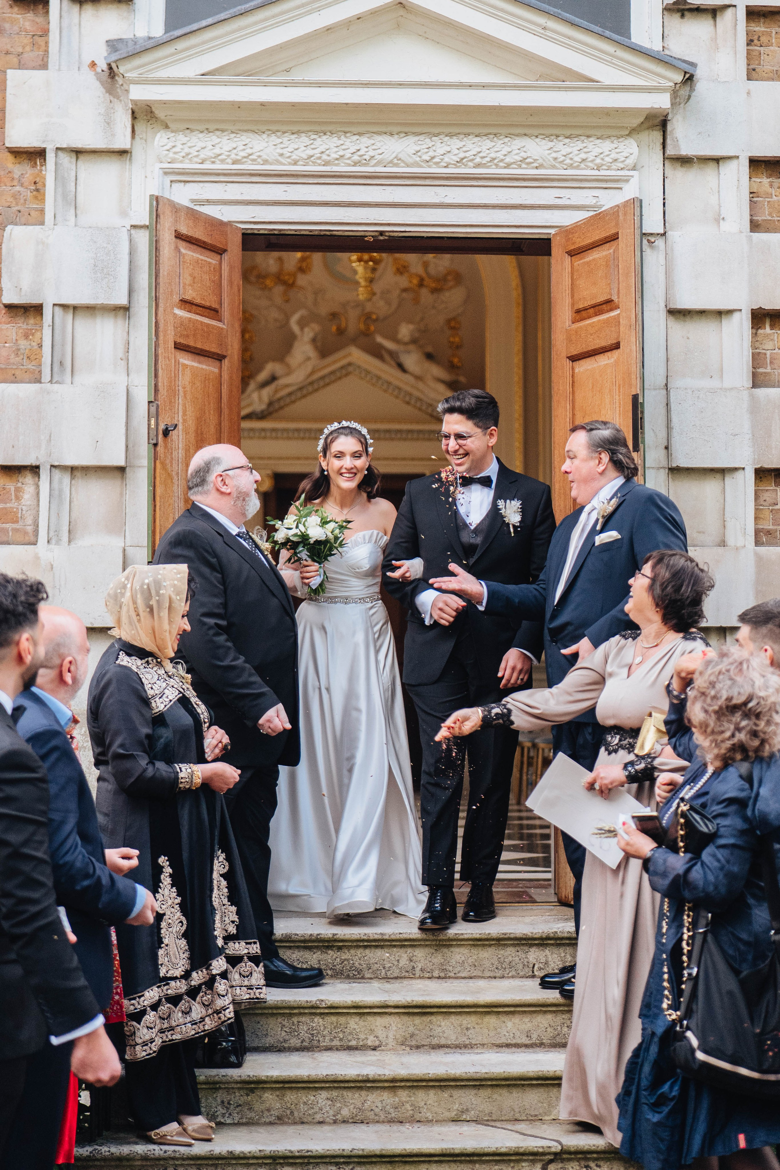 photo of the wedding ceremony, close up of bride and groom meeting guests at the exit