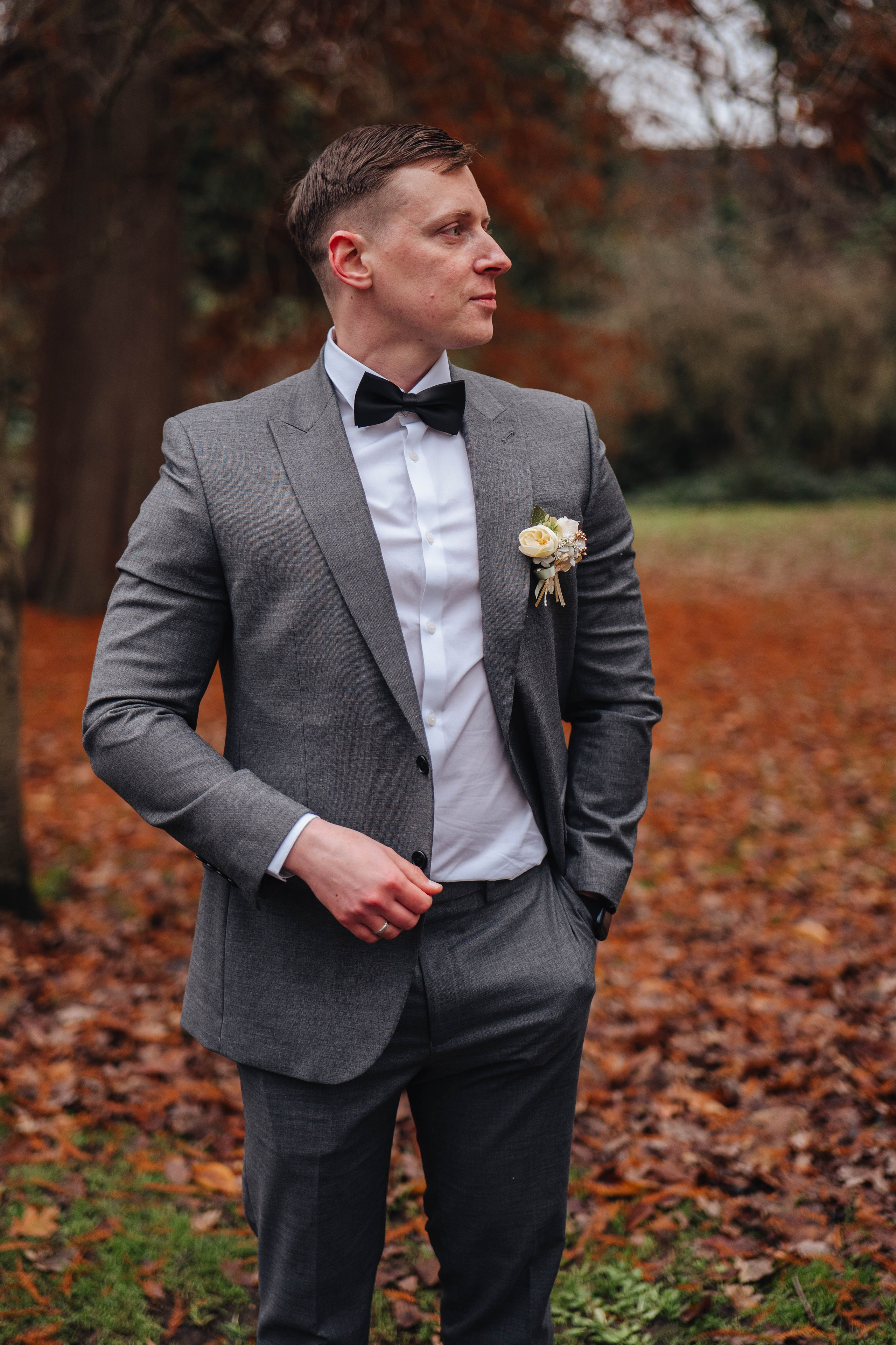 Handsome groom in autumn park in London