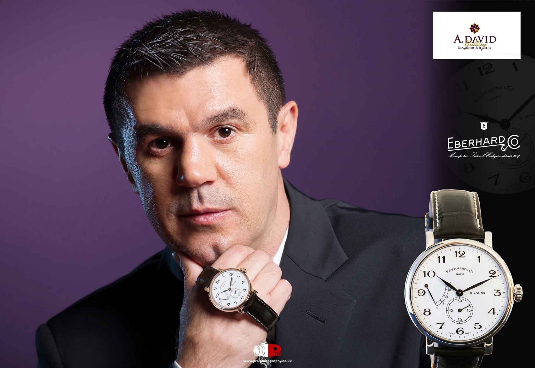 Close-up portrait of a businessman showcasing an Eberhard & Co luxury watch against a purple background.