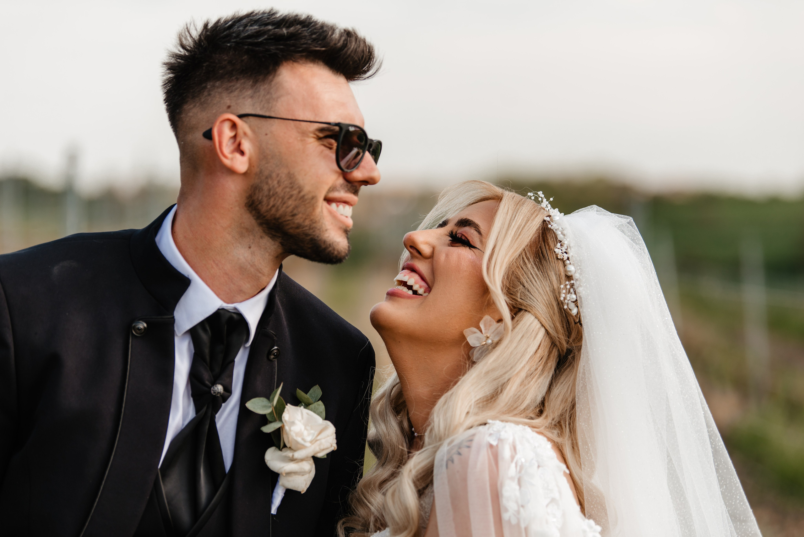 Radu Rahovan Fotograf de nuntă Cluj – mire și mireasă zâmbitori, în lan de vițǎ de vie, la apus, un moment plin de căldură.