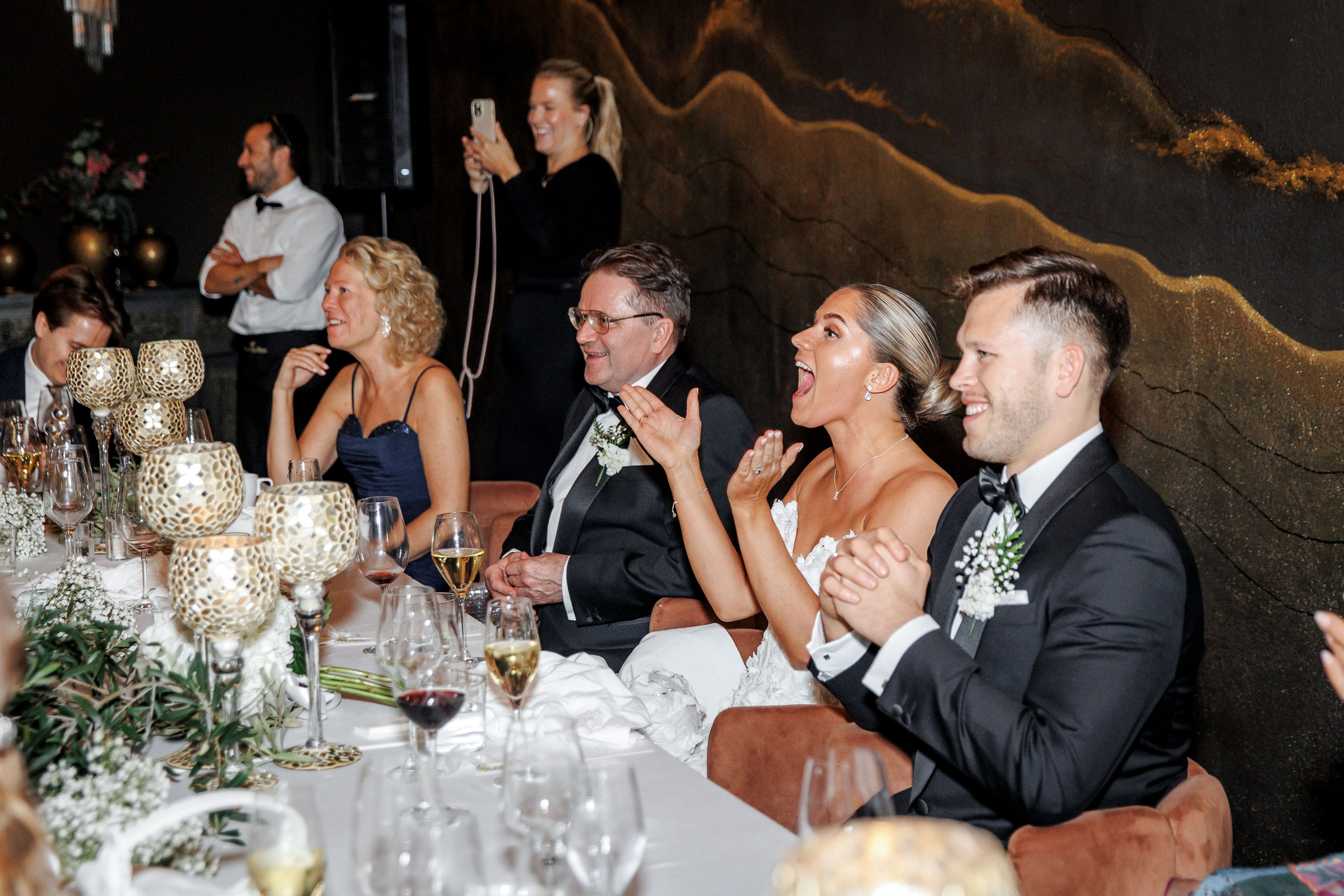 Bride laughing during the wedding performance of the best friends at the wedding in Barcelona. 