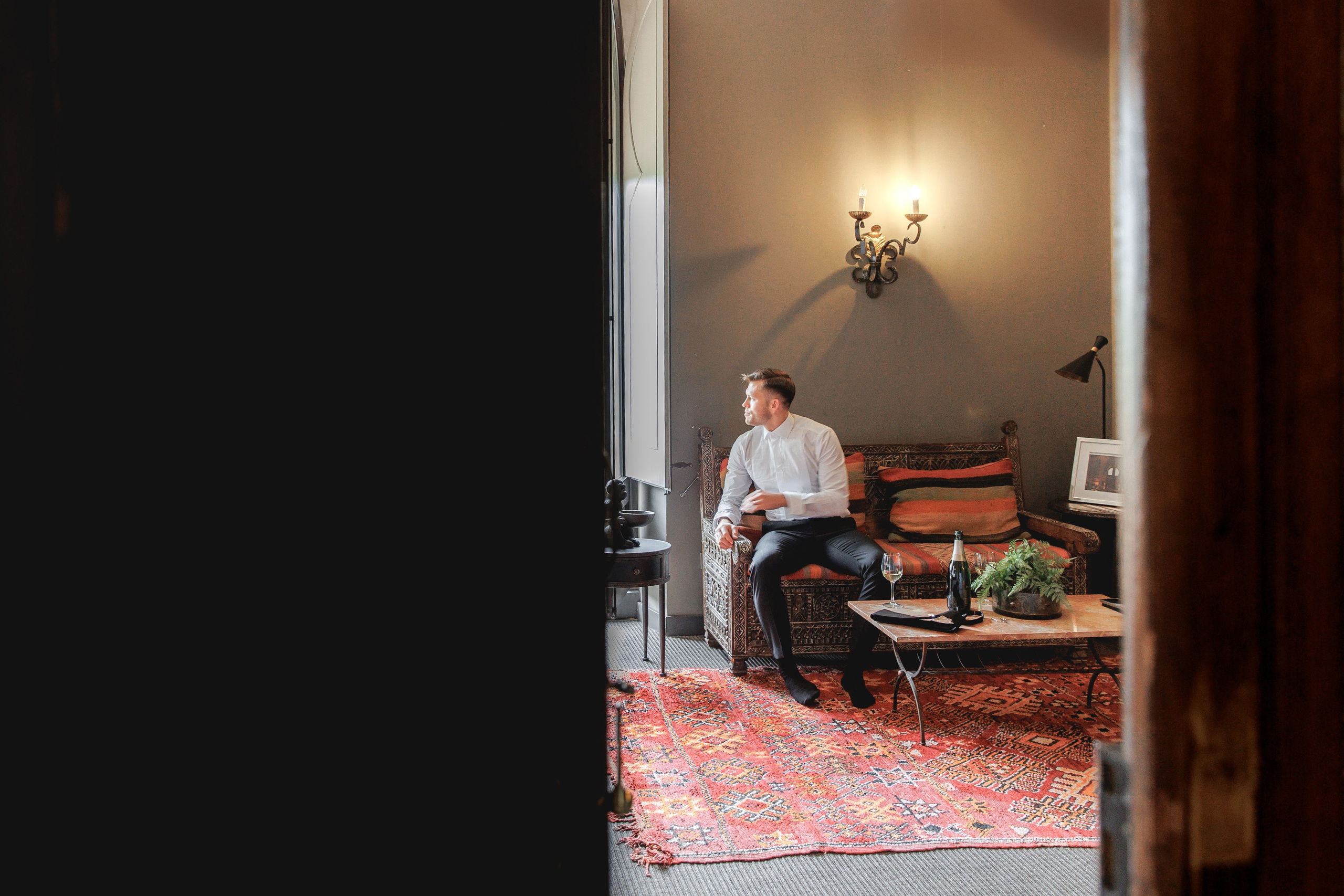 Stylish groom portrait captured in a picturesque Barcelona venue, showcasing elegant wedding attire.