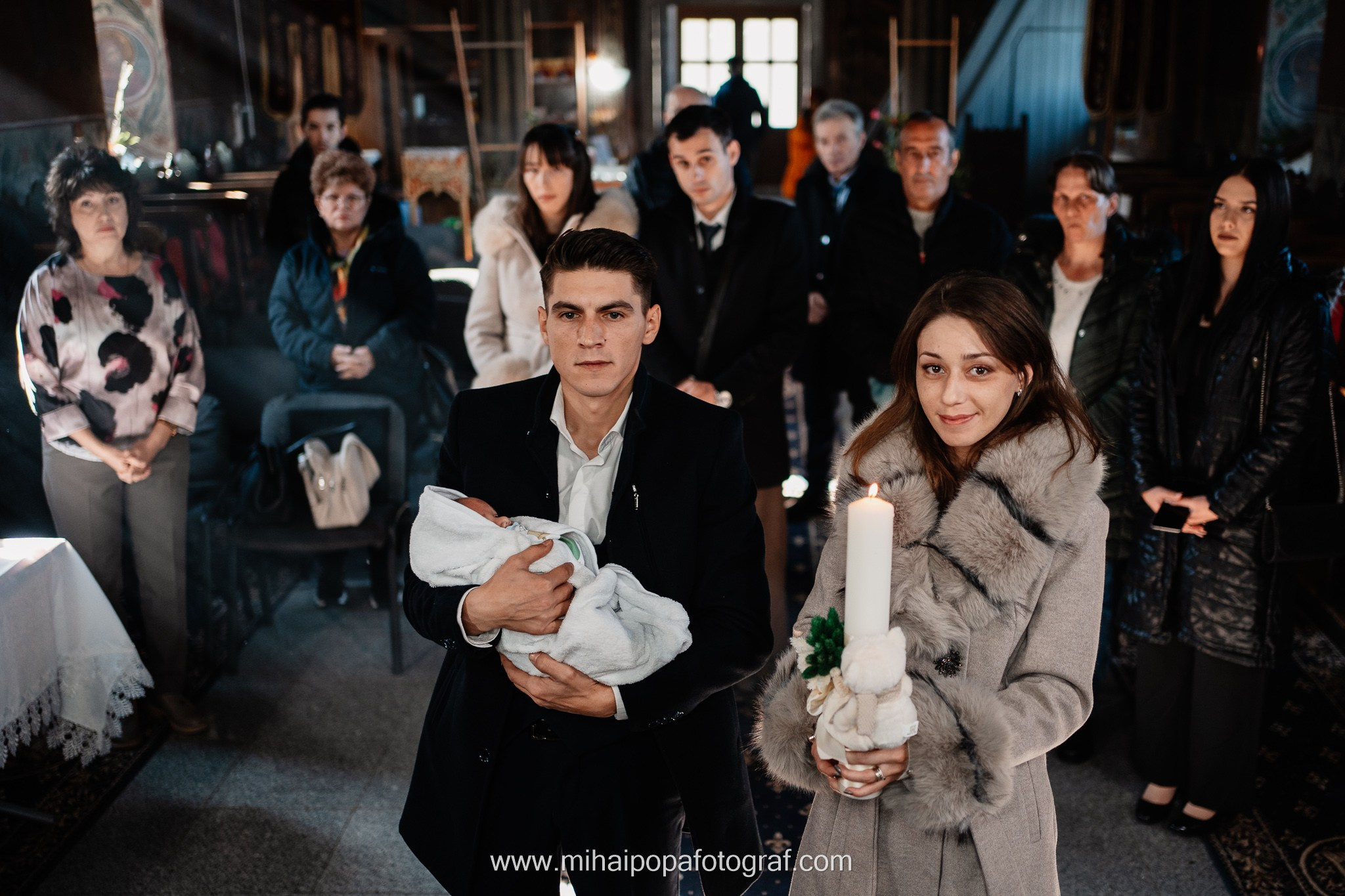 Instantaneu plin de tandrețe dintre părinți și bebeluș în ziua botezului, realizat în ilfov. Fotografie profesională de botez, capturând emoțiile autentice ale familiei într-un decor luminos și cald