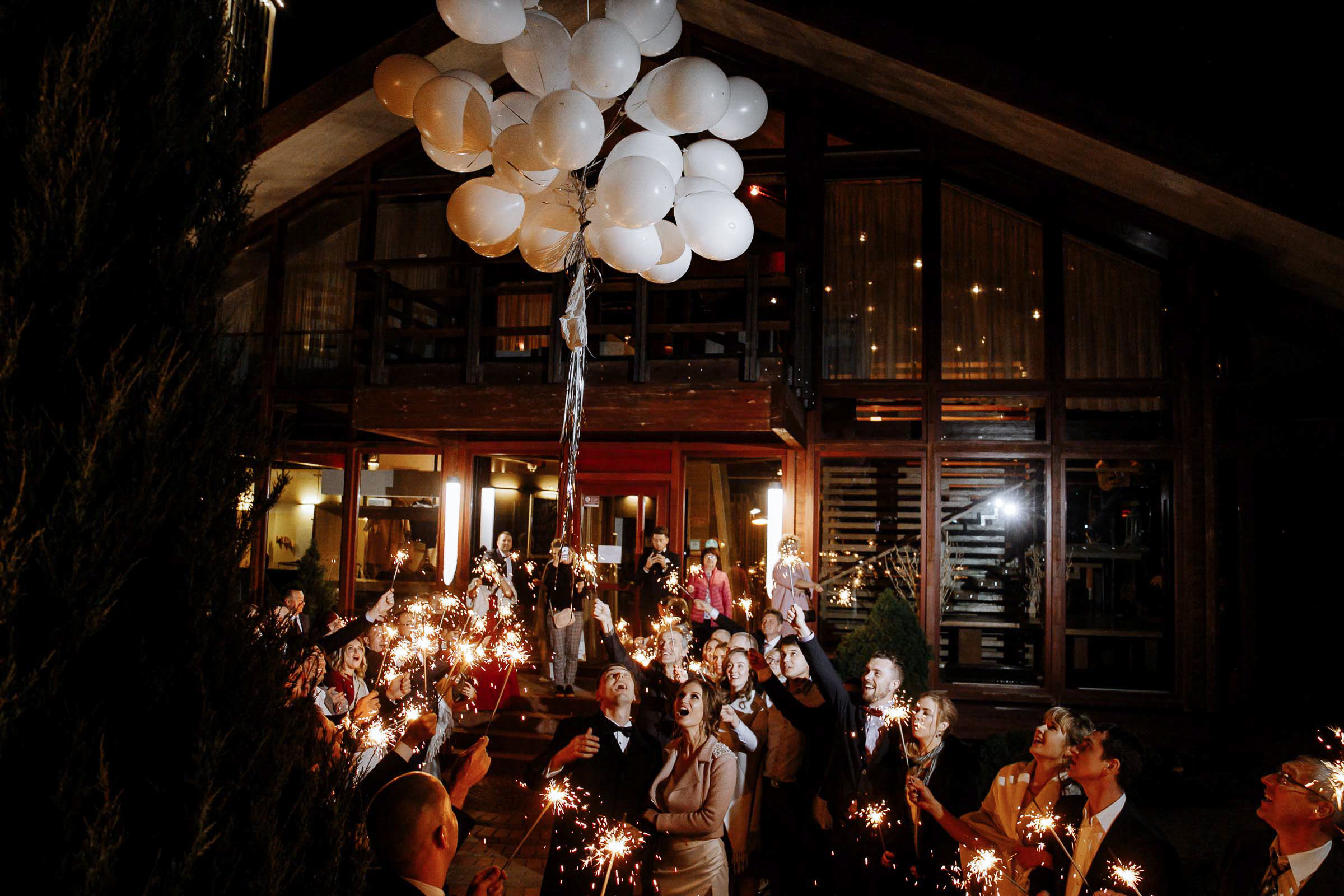 Sparkler moment with balloons, by Tanya Bodgan, Bude wedding photographer.  