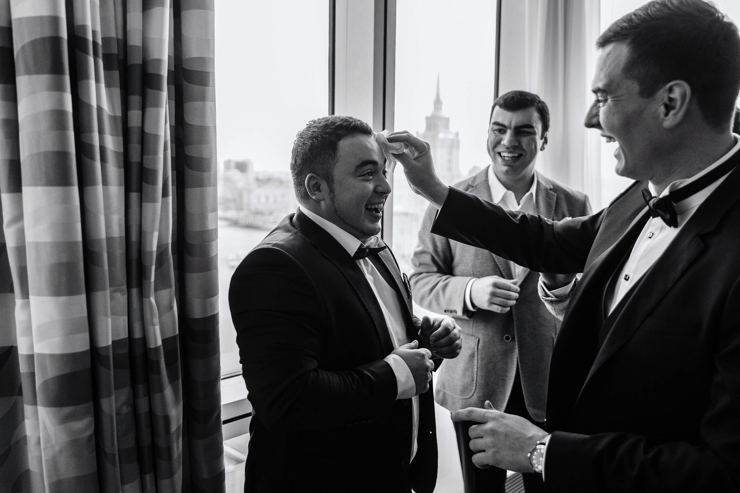 Groom’s candid prep with groomsmen, by Tanya Bodgan, Bude wedding photography.  