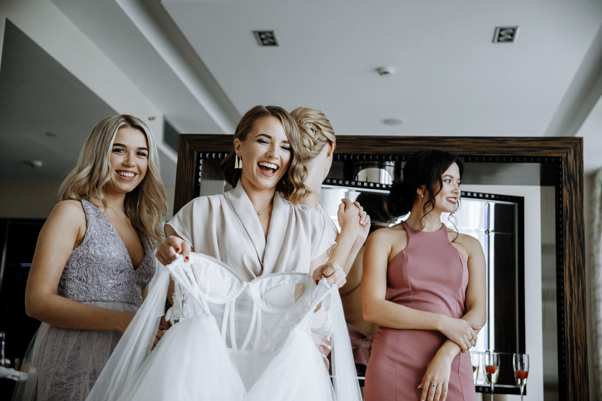 Bridesmaids laughing in room, by Tanya Bodgan, Bude wedding photographer.  