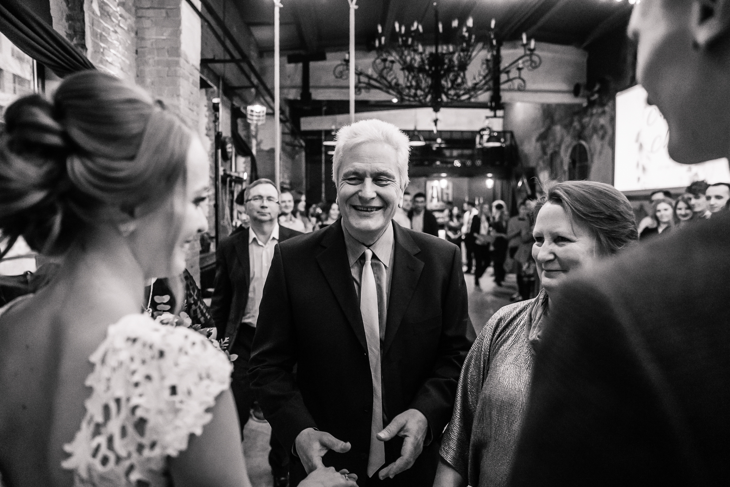 Guests congratulating bride in black and white, by Tanya Bogdan, Bude, Cornwall wedding photographer.  