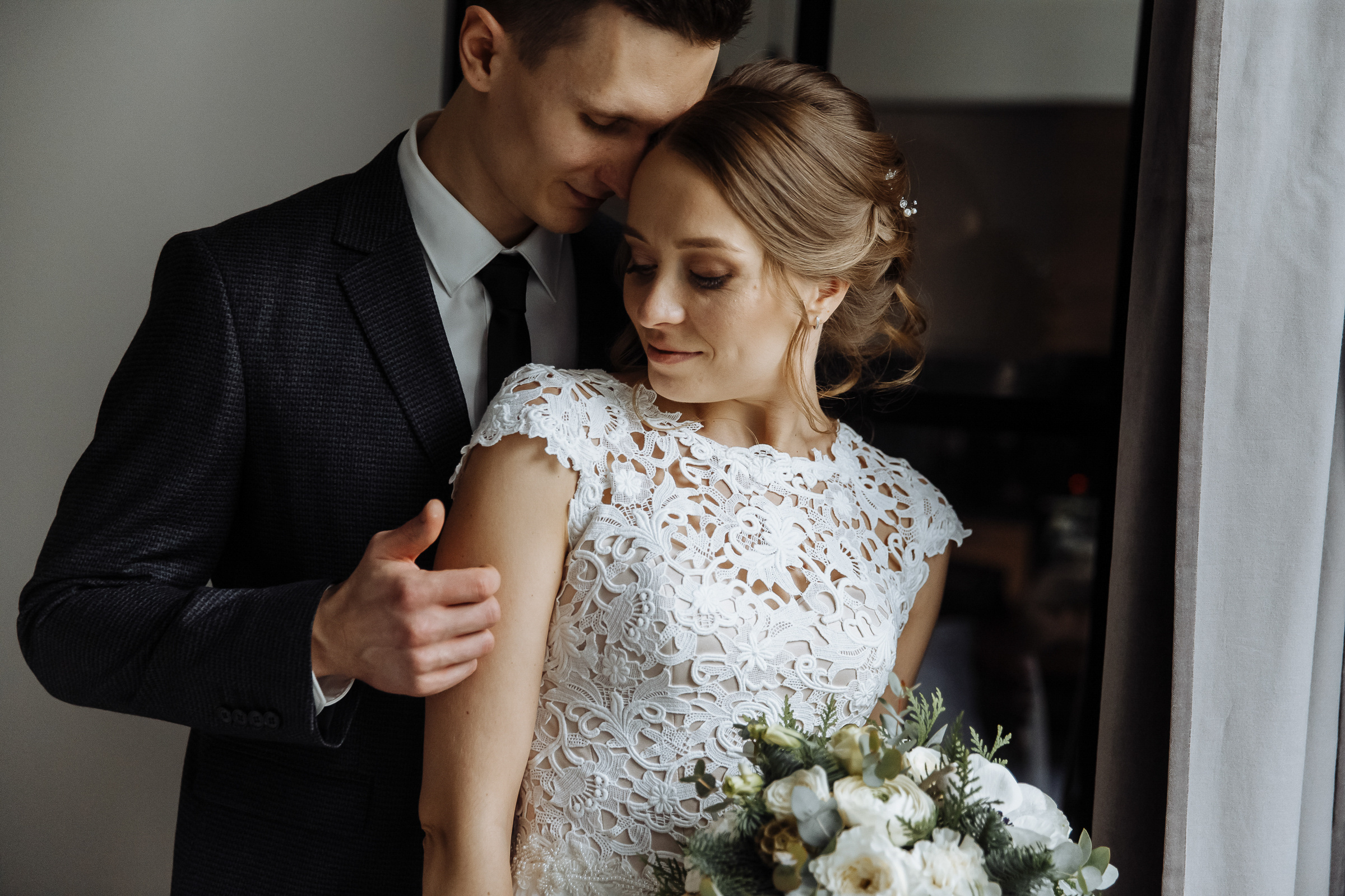 Couple’s morning embrace in room, by Tanya Bogdan, Bude wedding photography.  