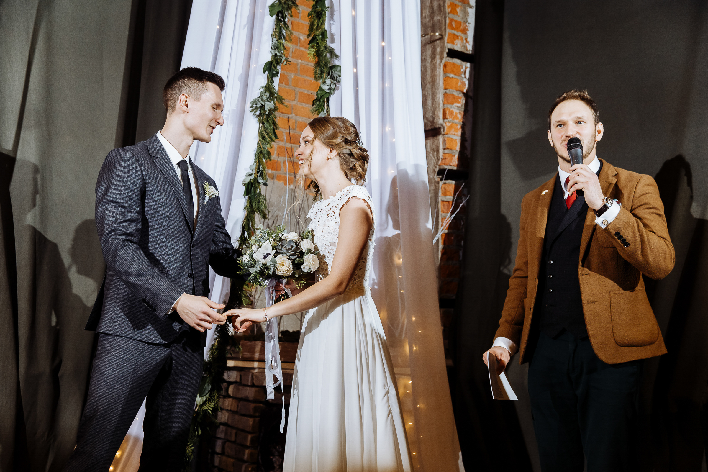 Couple holding hands in urban light, by Tanya Bogdan, Bude wedding photography.  