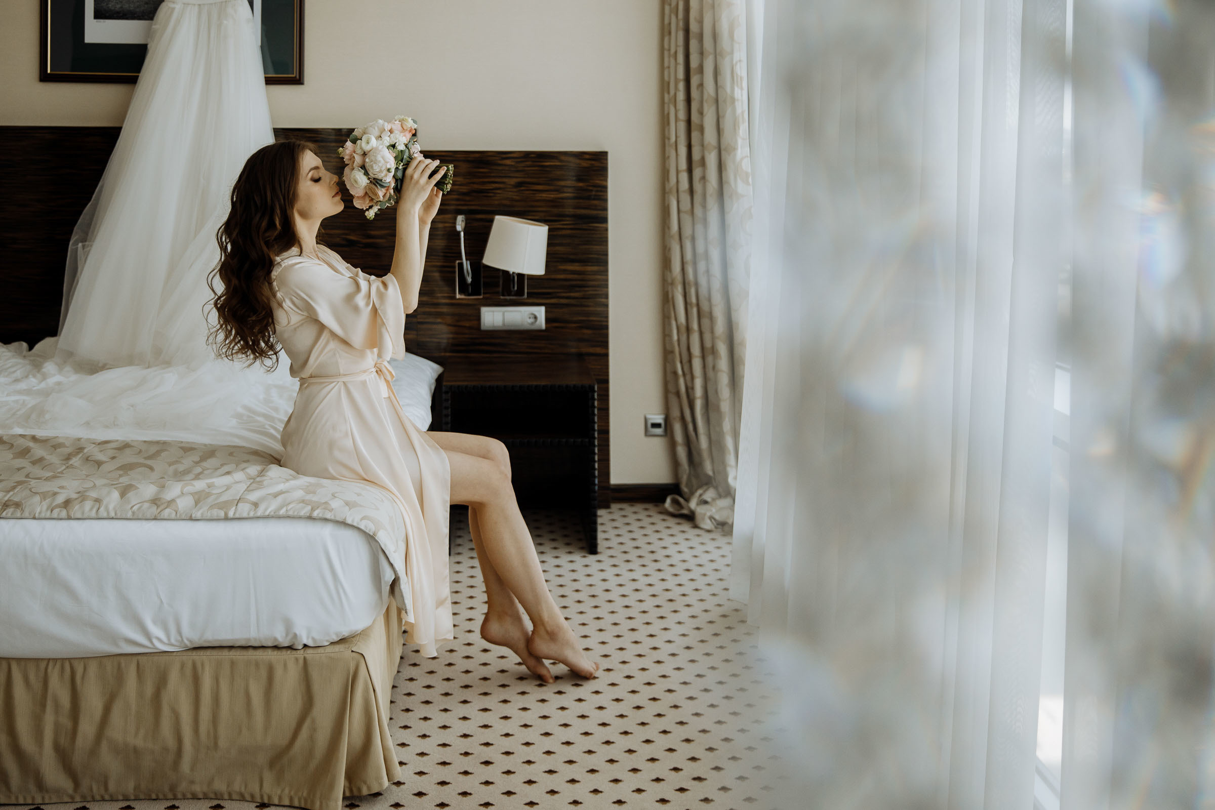Bride’s candid morning portrait in suite, by Tanya Bogdan, Bude editorial and reportage wedding photography.  