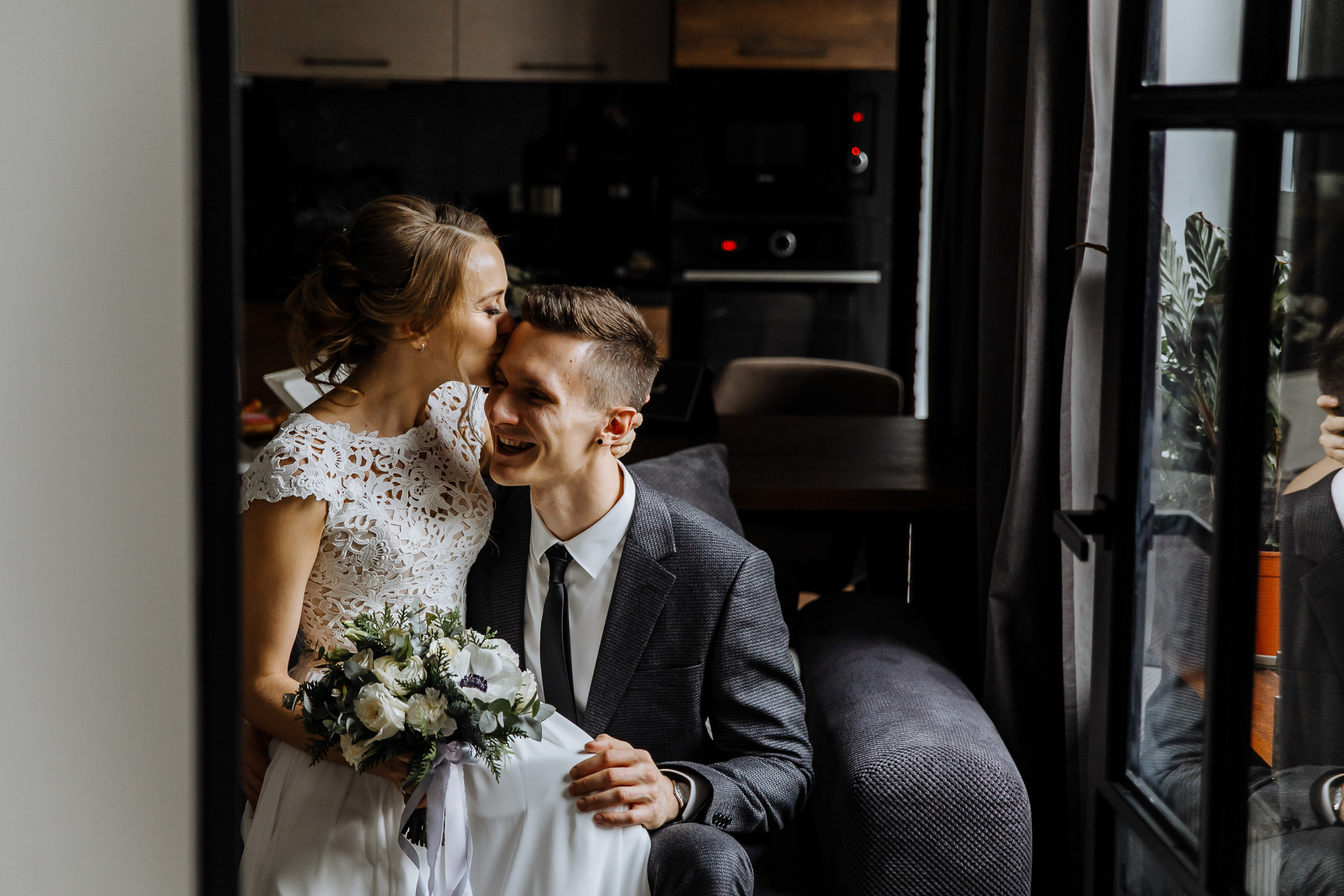 Couple’s portrait in home living room through doorway, by Tanya Bogdan, Bude wedding photography.  