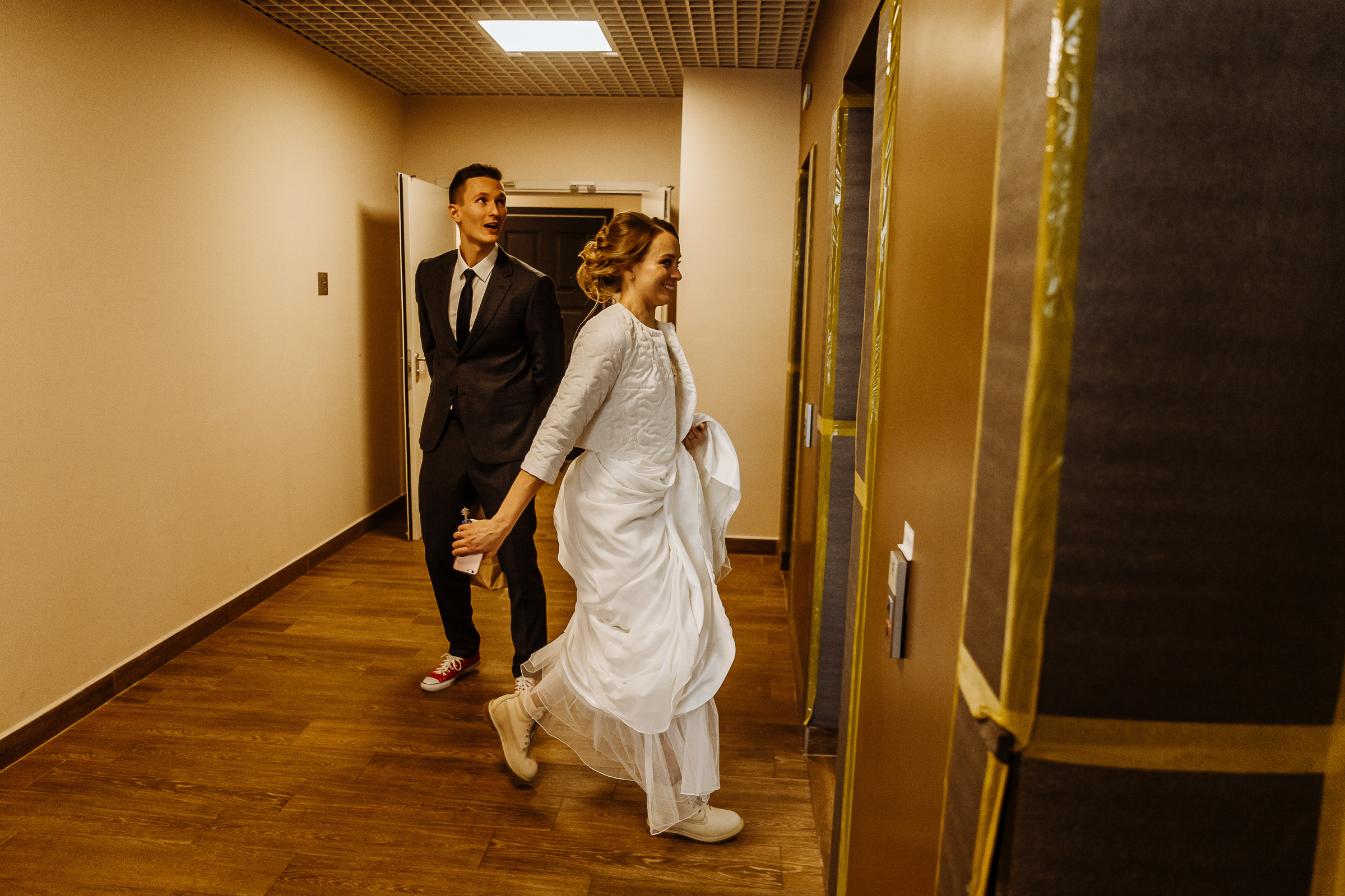 Couple walking to lift, by Tanya Bogdan, Bude wedding photography.  