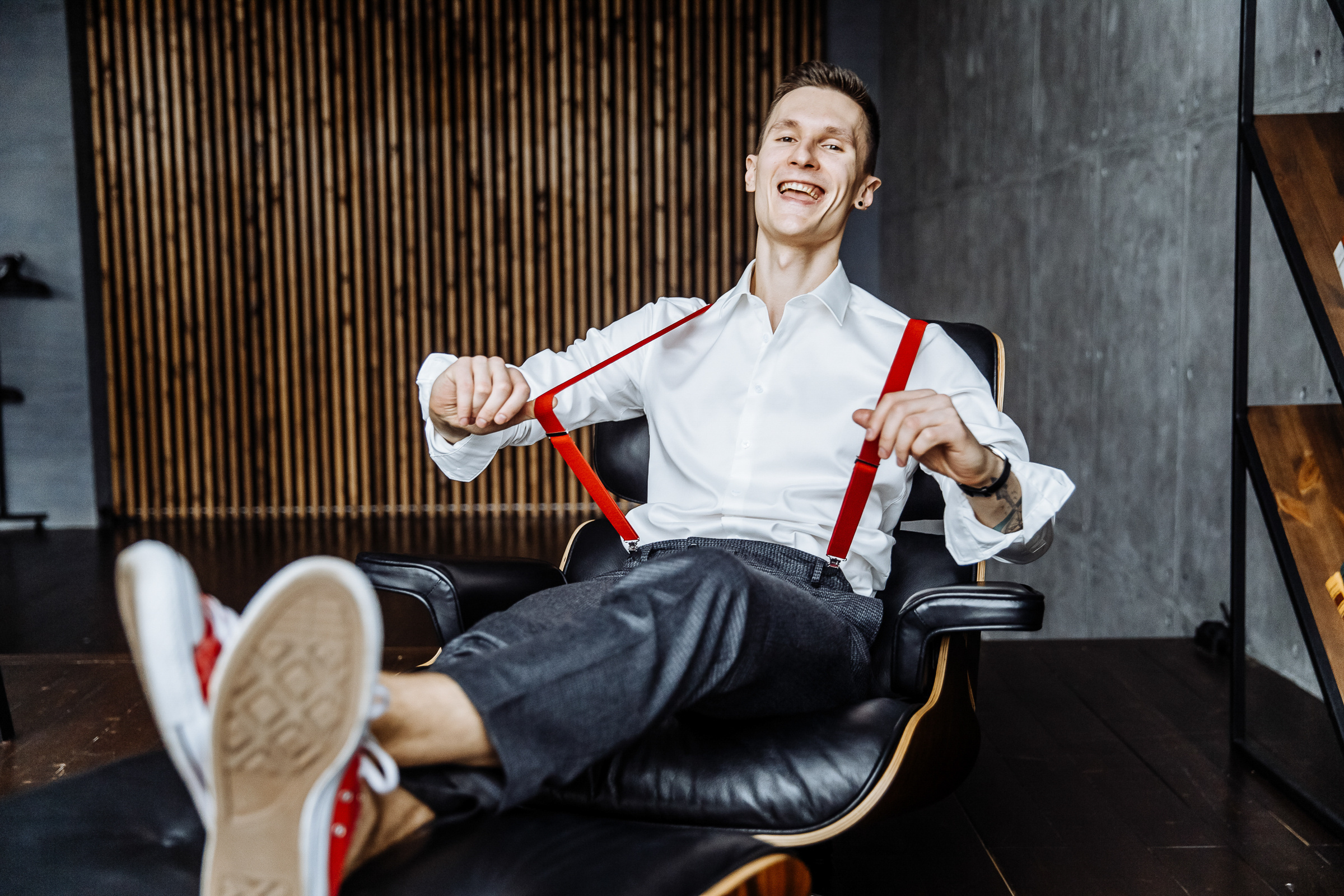 Groom in red Converse boots with feet up, by Tanya Bogdan, Cornwall wedding photographer.  