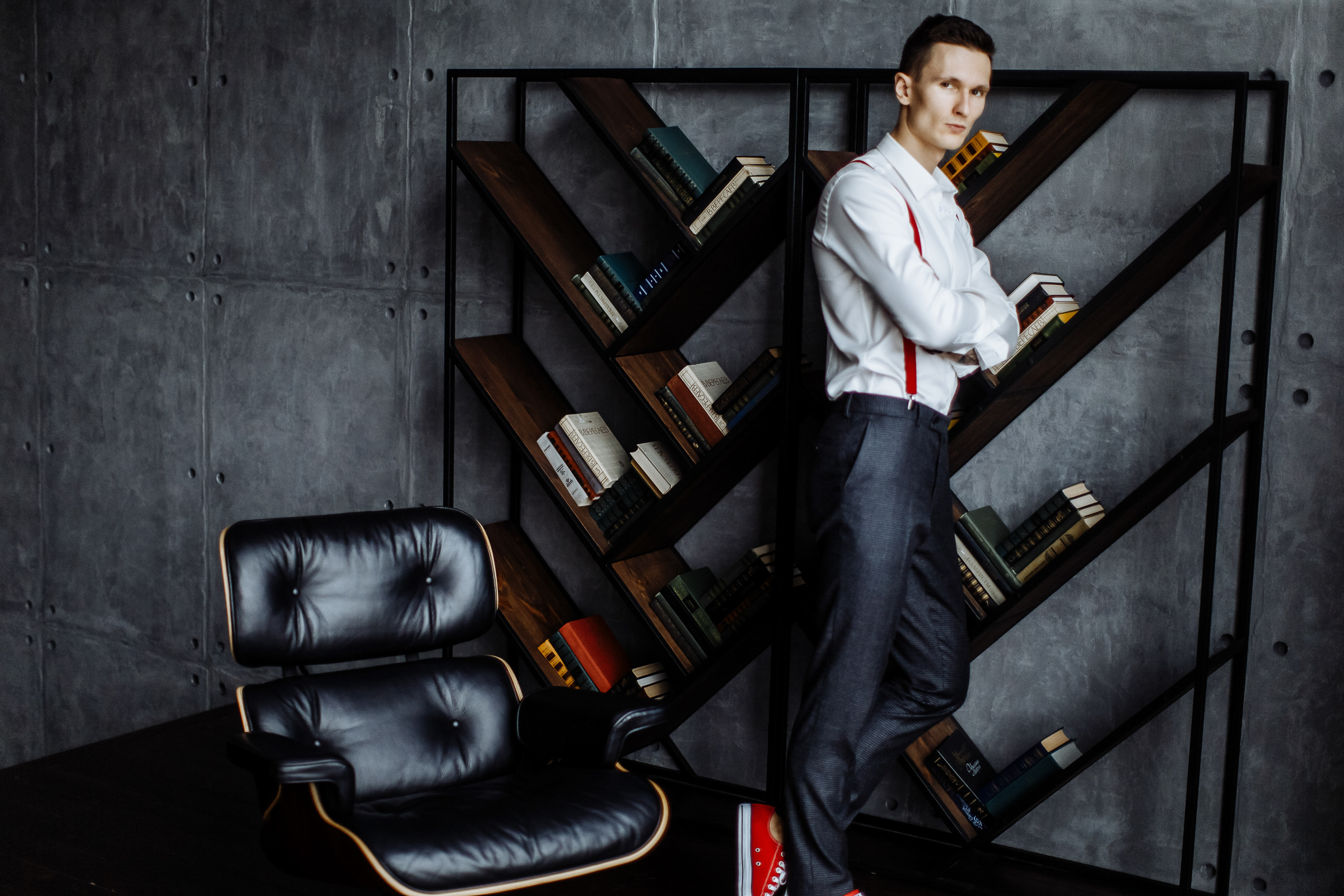 Groom in red Converse boots by wall, by Tanya Bogdan, Falmouth wedding photographer.  