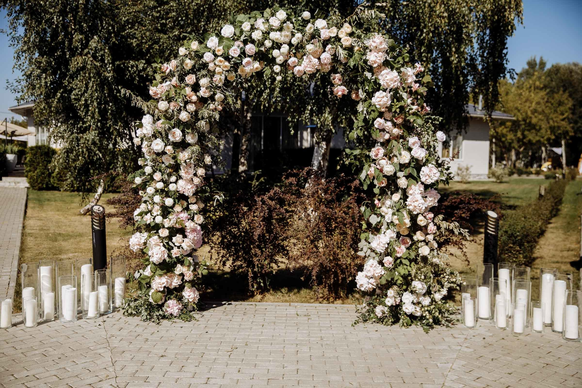 Outdoor ceremony decor with floral arch, by Tanya Bogdan, Exeter wedding photographer.  