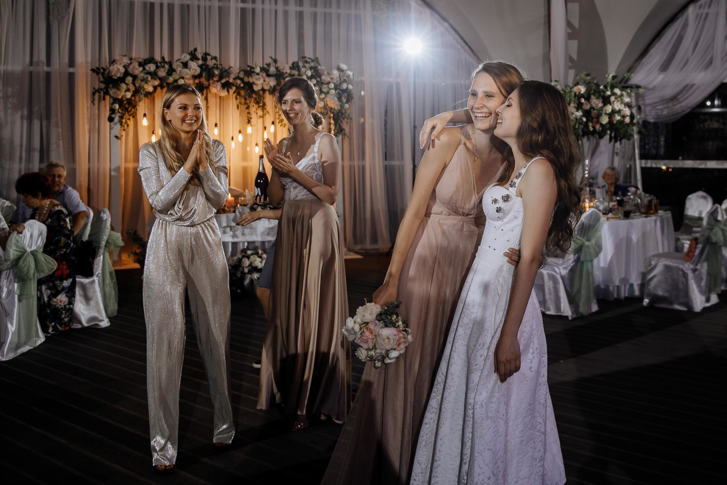 Bride congratulating bridesmaid, by Tanya Bogdan, Bude wedding photography.  