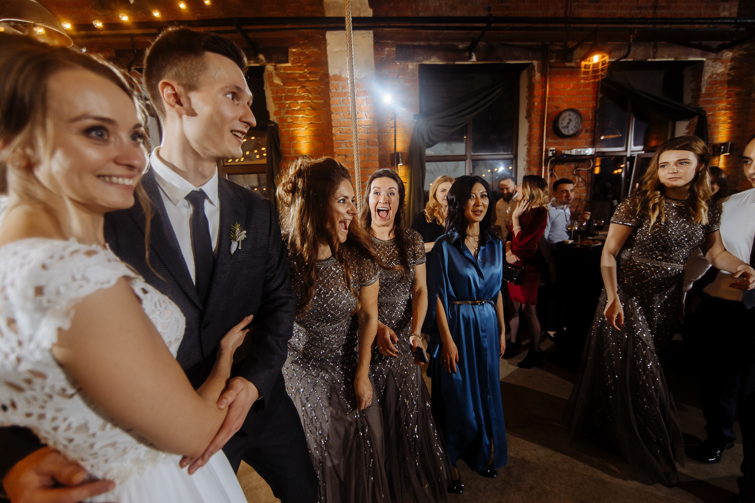 Guests smiling with bride and groom, by Tanya Bogdan, Bude, Cornwall wedding photographer.  