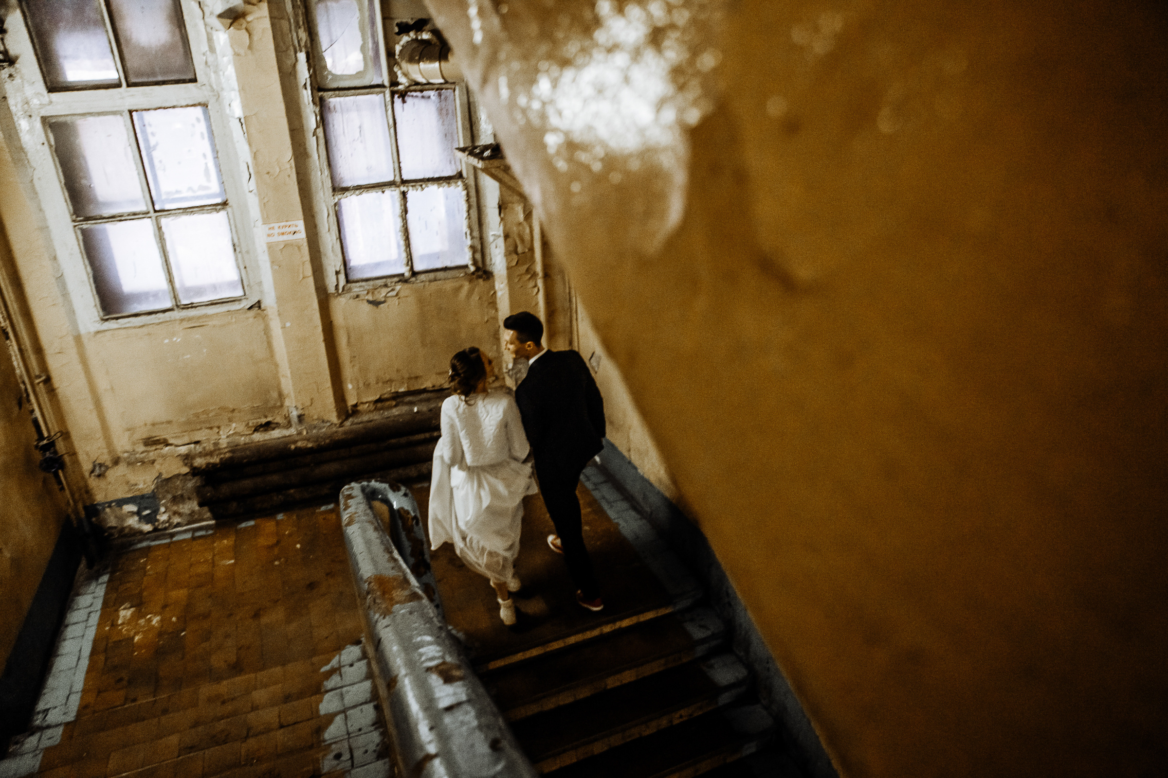 Bride and groom up stairs to studio, by Tanya Bogdan, Bude wedding photography.  