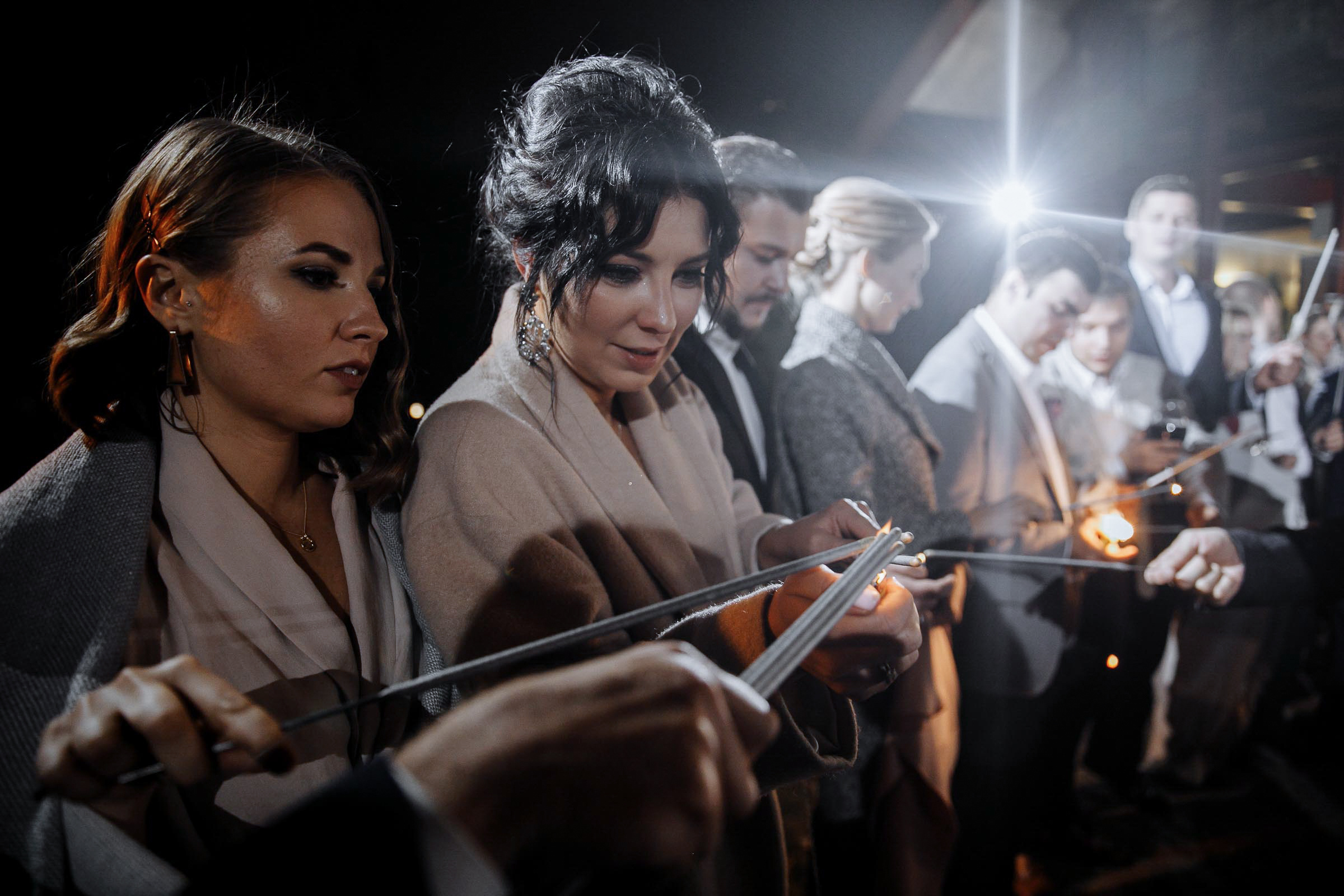 Guests preparing sparklers, by Tanya Bodgan, Newquay wedding photographer.  