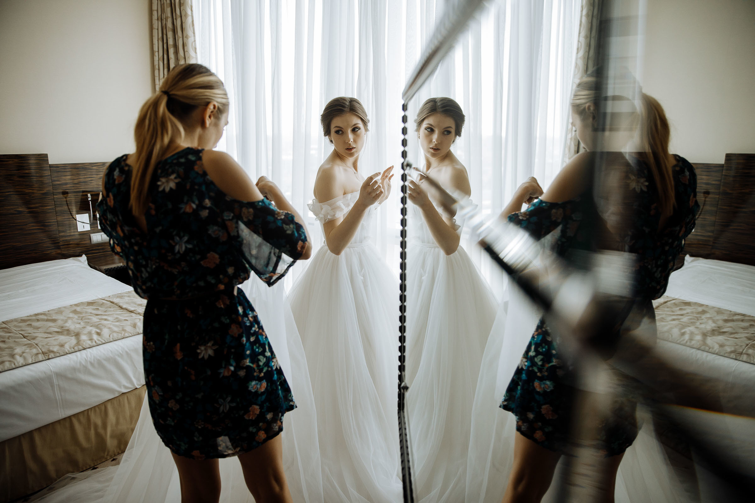 Checking dress in mirror, by Tanya Bogdan, Bude, Cornwall wedding photographer.  