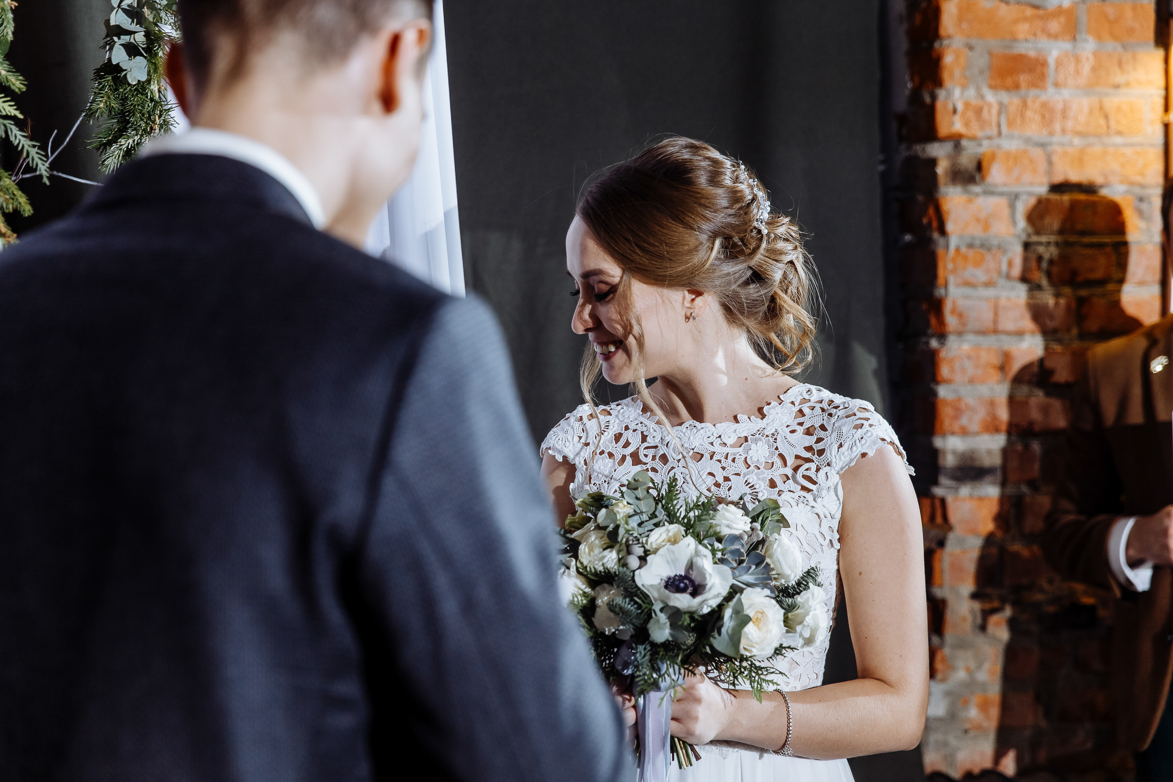 Bride’s ceremony smile in hall, by Tanya Bogdan, Truro wedding photographer.  