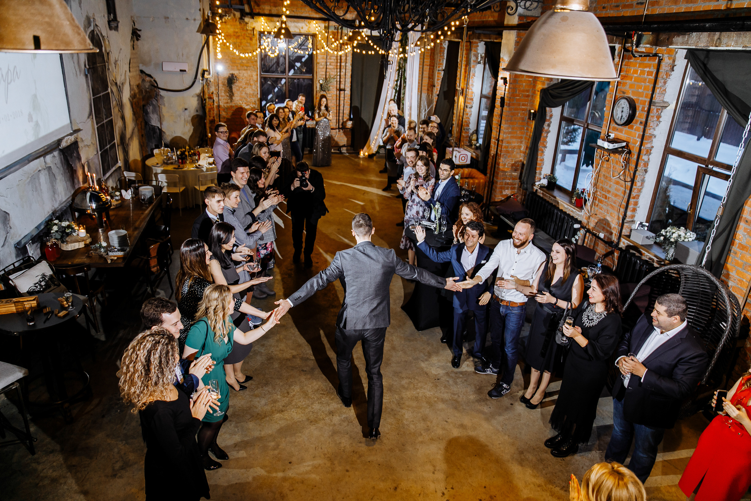 Groom greeted in urban hall, by Tanya Bogdan, Bude  wedding photography.  