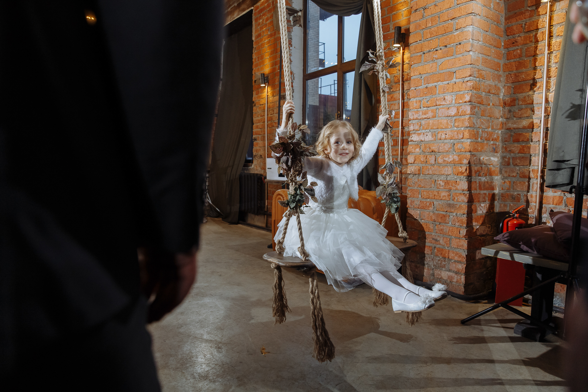 Child on swing, by Tanya Bogdan, Exeter wedding photographer.  