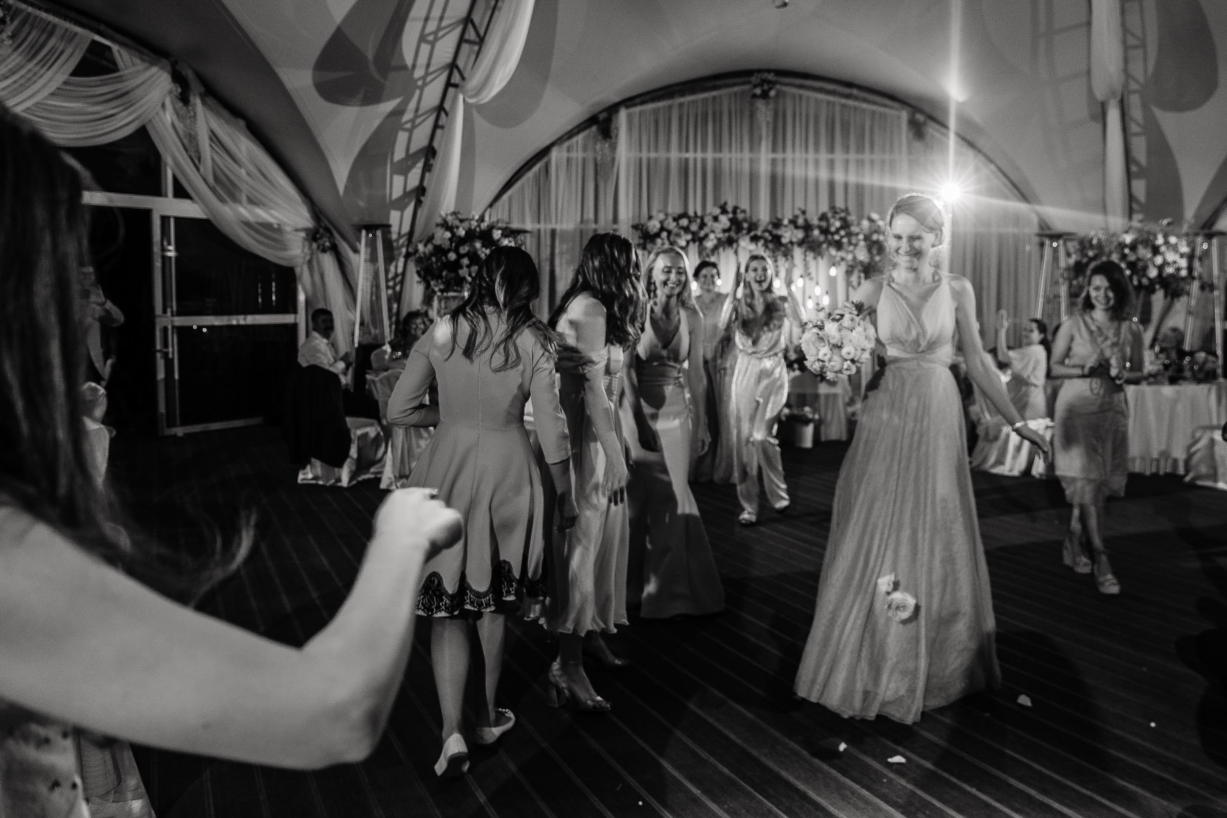 Bouquet toss winner in black and white, by Tanya Bogdan, Bude wedding photography.  