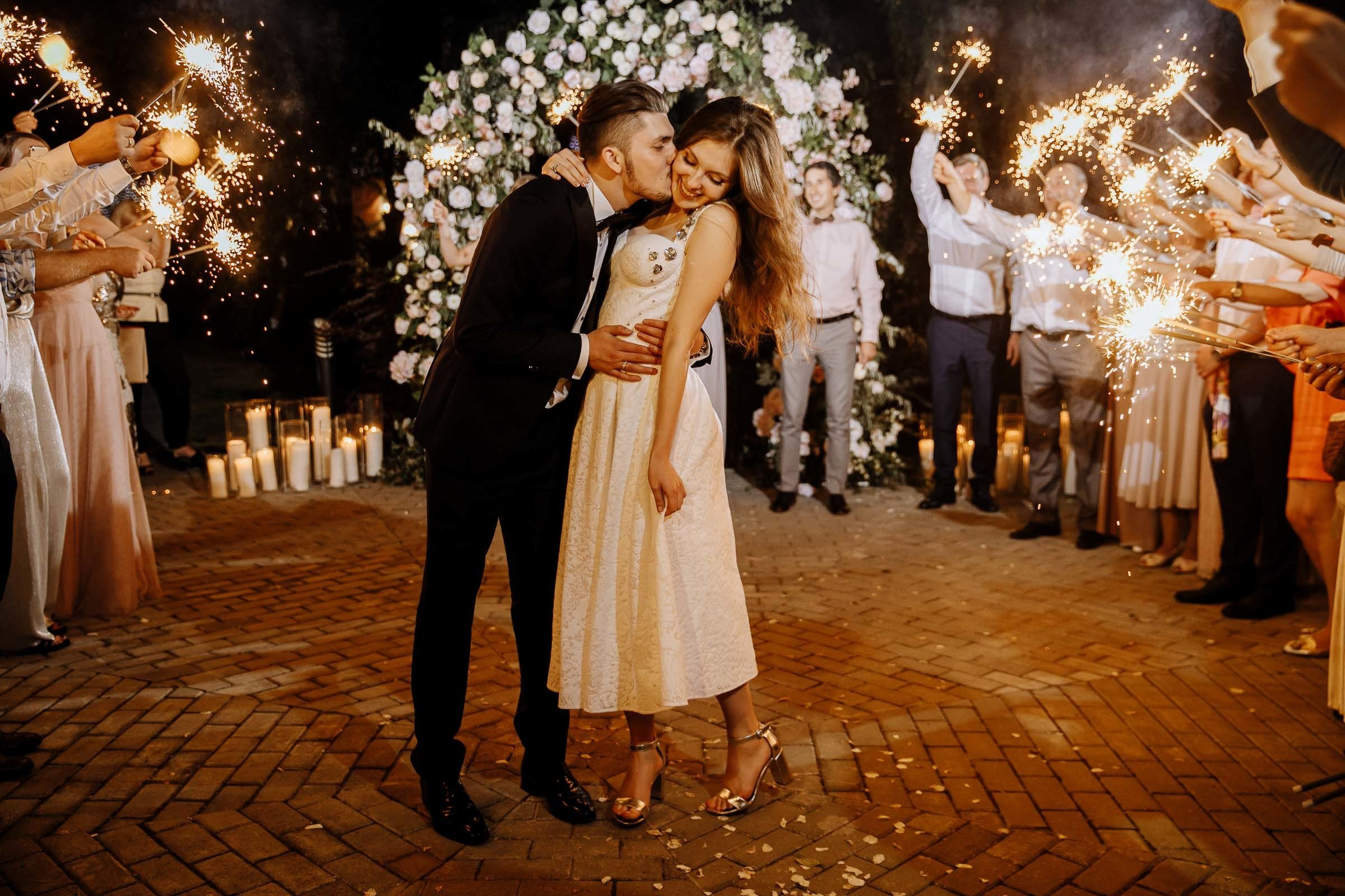 Guests waving sparklers, by Tanya Bogdan, St Ives wedding photography.  