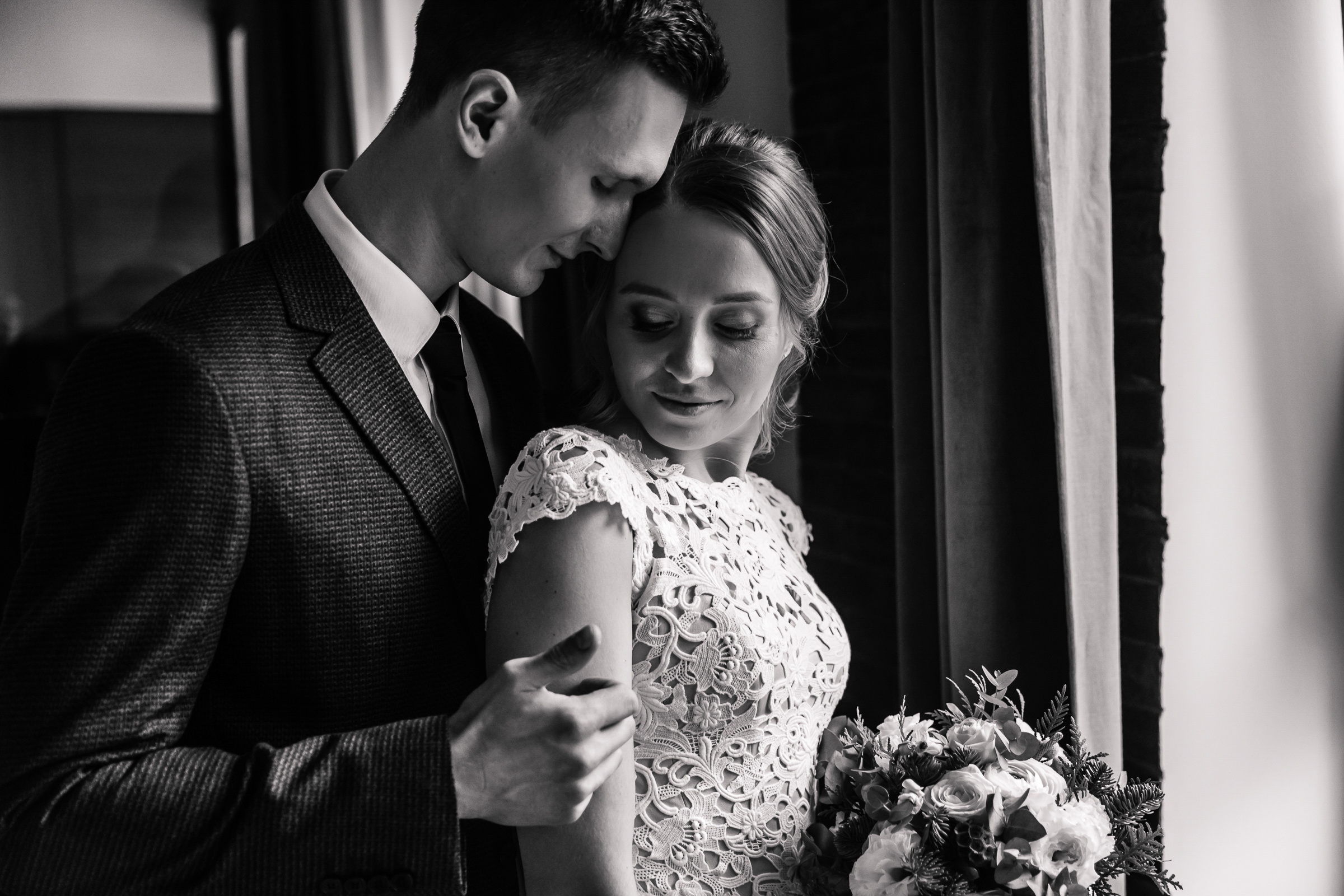 Couple’s portrait by window, by Tanya Bogdan, Plymouth wedding photography.  