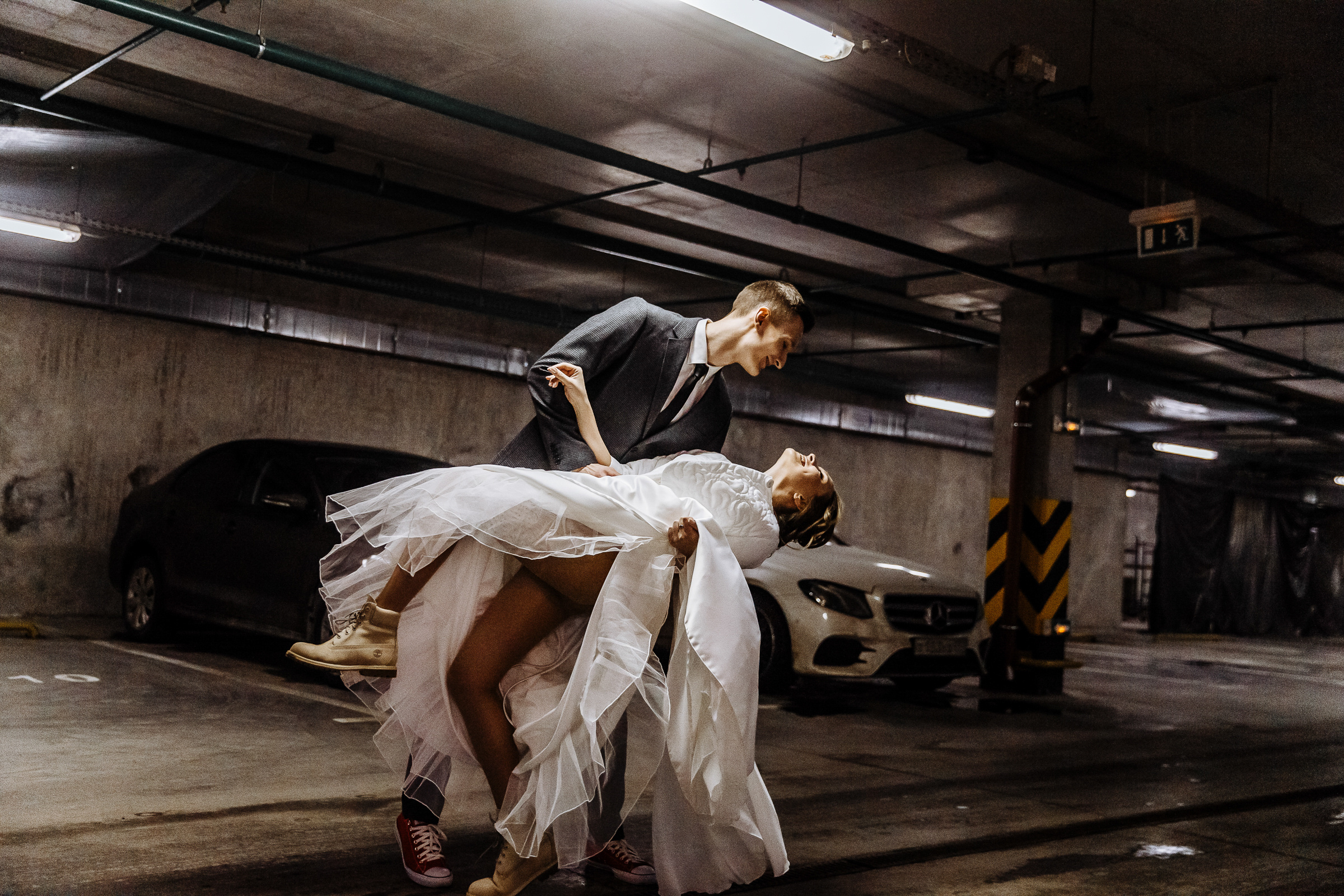 Groom dips bride in car park, by Tanya Bogdan, Bude wedding photography.  