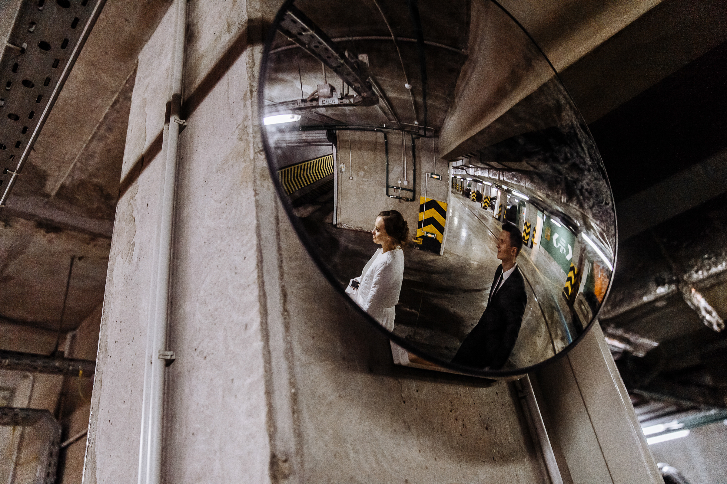 Couple walking in car park, by Tanya Bogdan, Bude wedding photography.  