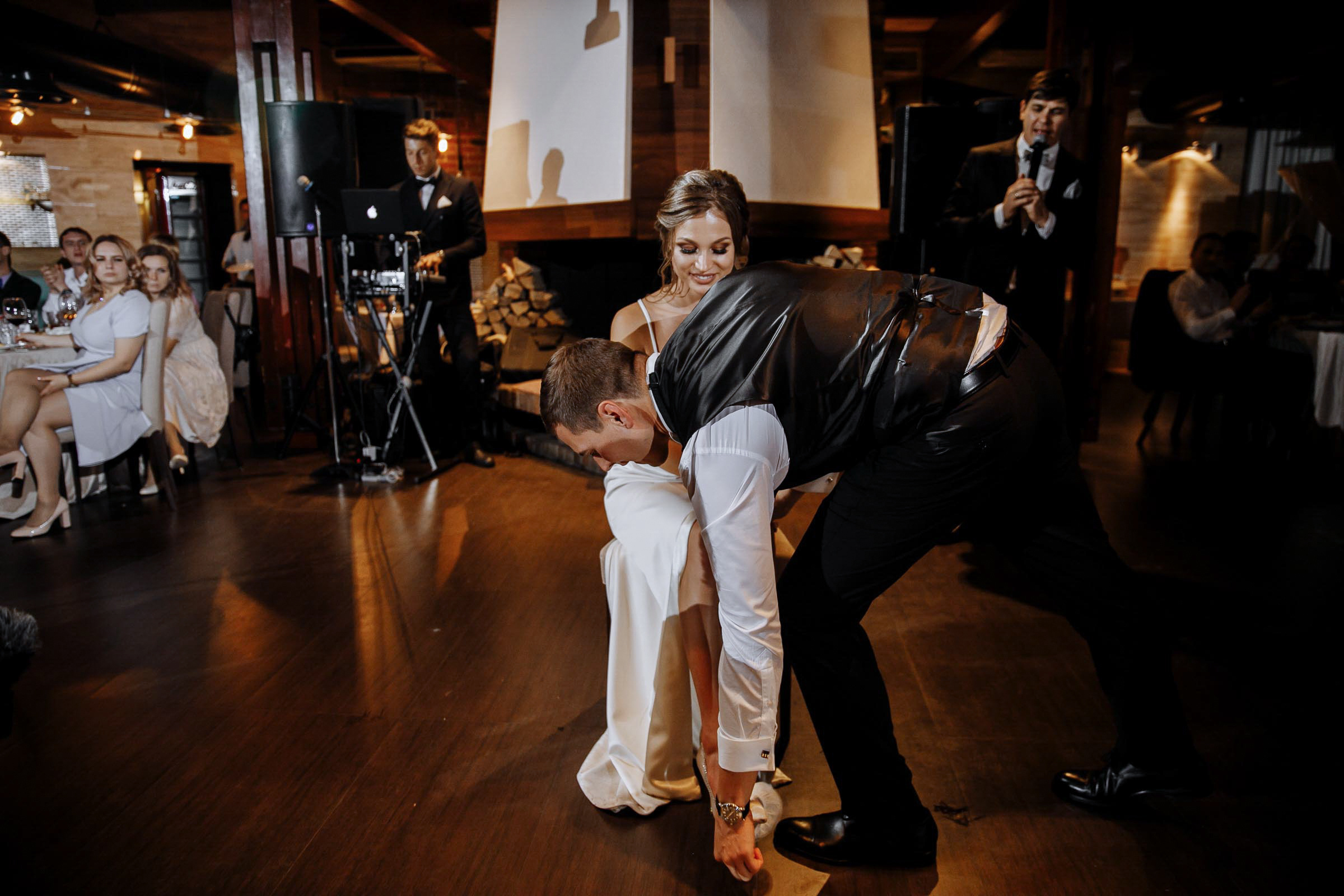 Groom getting the garter by Tanya Bodgan, Cornwall wedding photographer.  