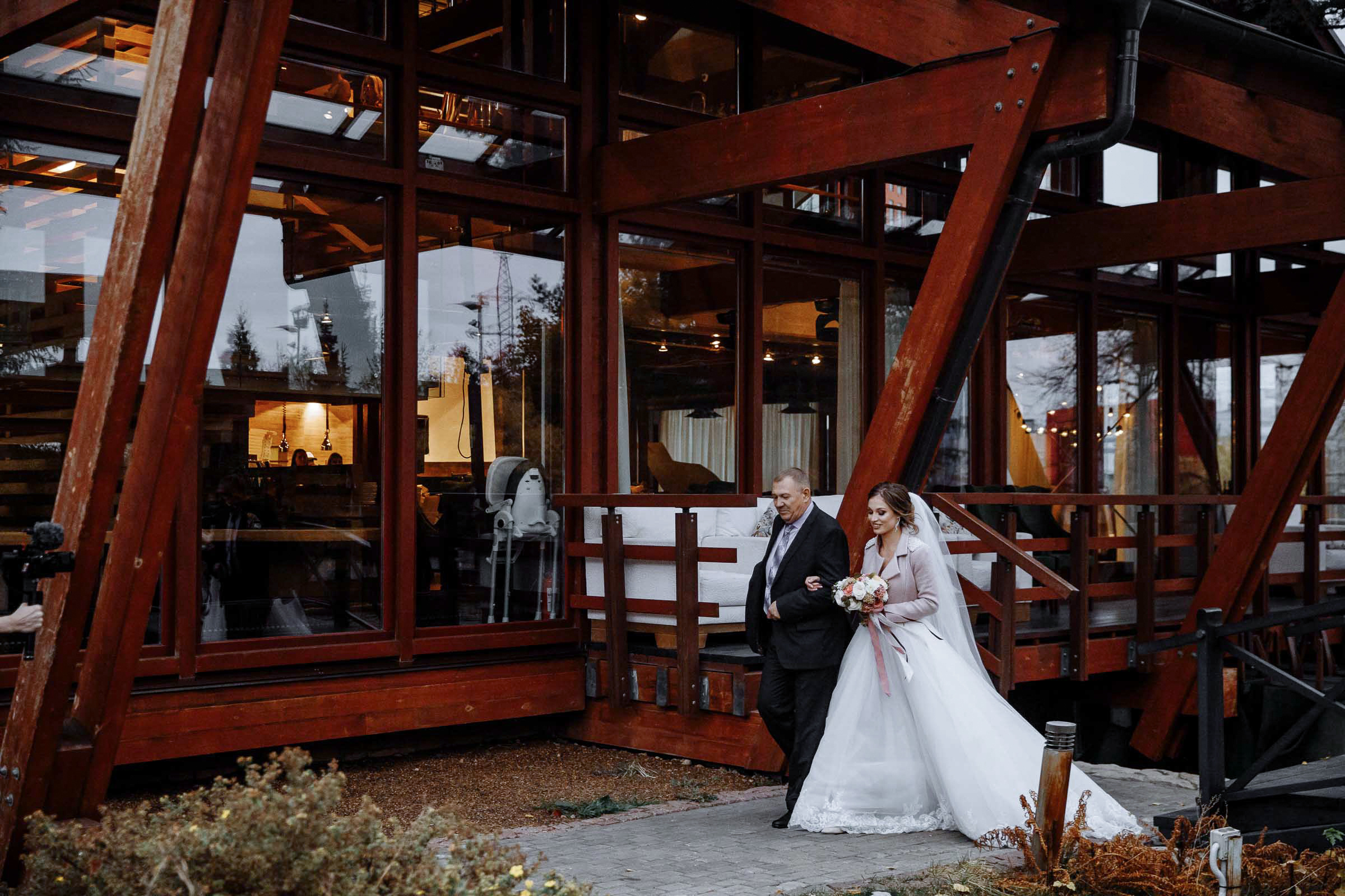 Bride walking down aisle in hotel venue with father, by Tanya Bodgan, Bude, Cornwall wedding photographer.  