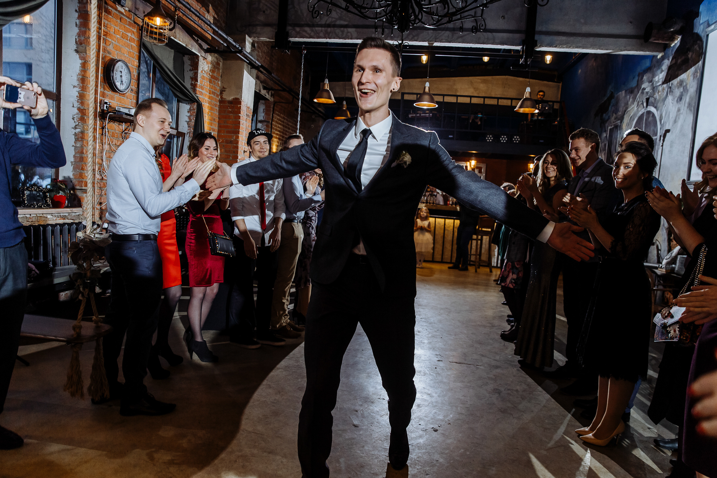 Groom entering urban hall, by Tanya Bogdan, St Ives wedding photography.  