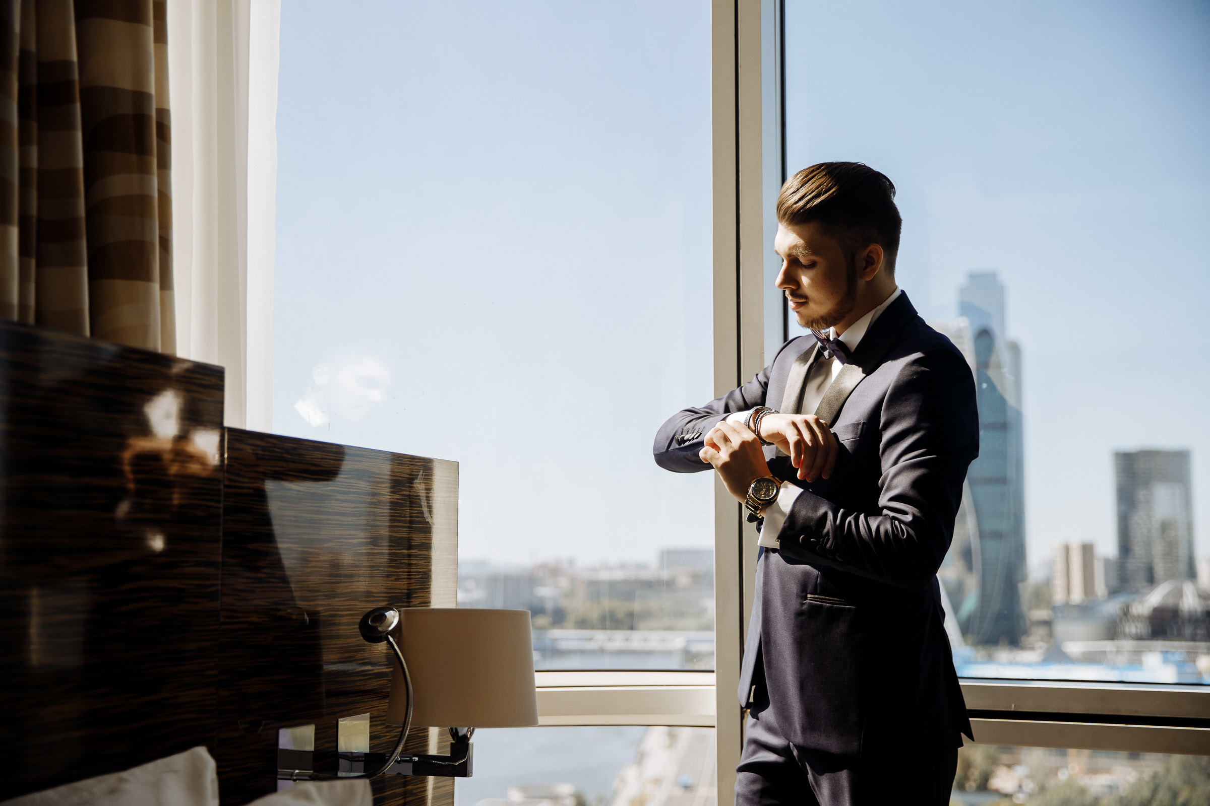 Groom adjusting cufflinks, by Tanya Bogdan, Bude wedding photography.  