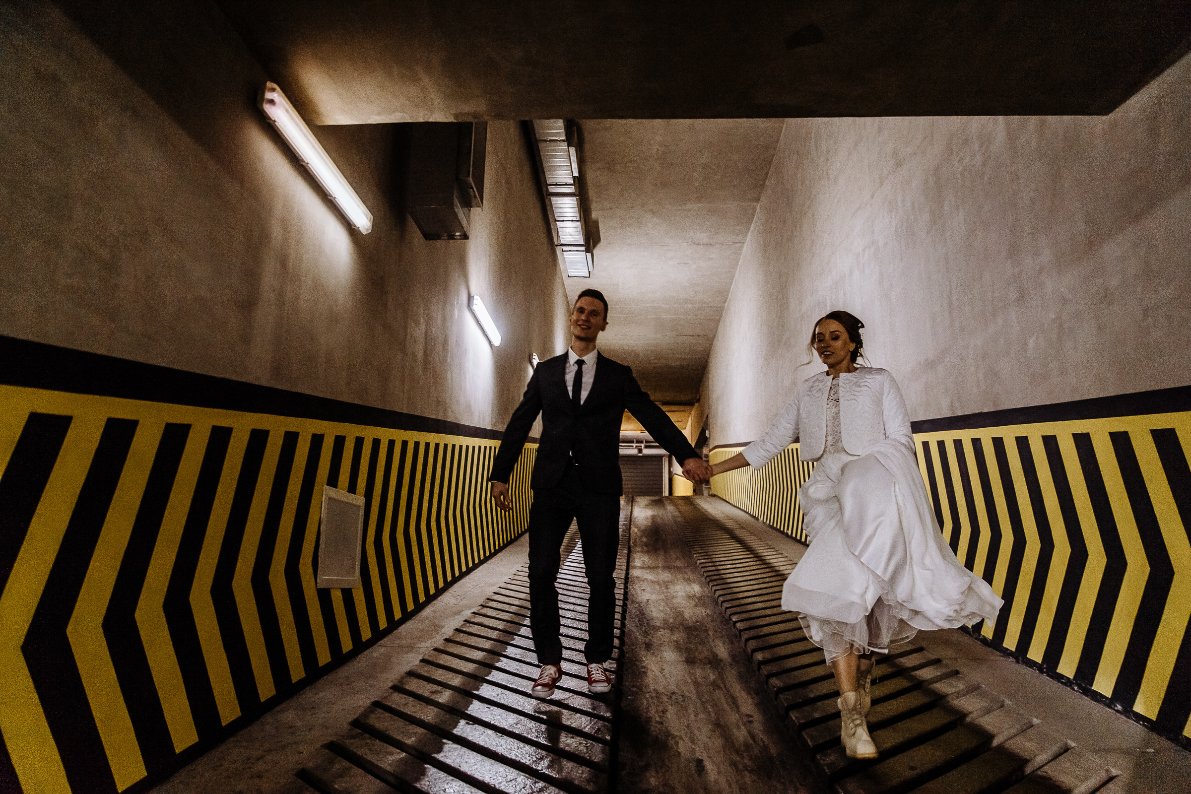 Couple walking in car park, by Tanya Bogdan, Bude wedding photography.  