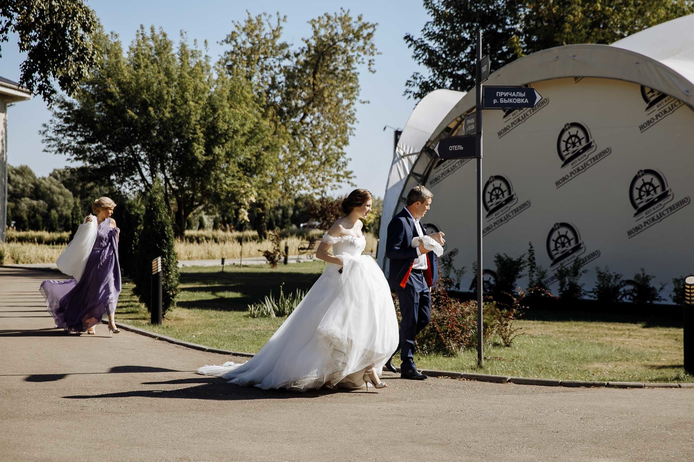 Bride walking down aisle in garden, by Tanya Bogdan, Bude, Cornwall wedding photographer.  
