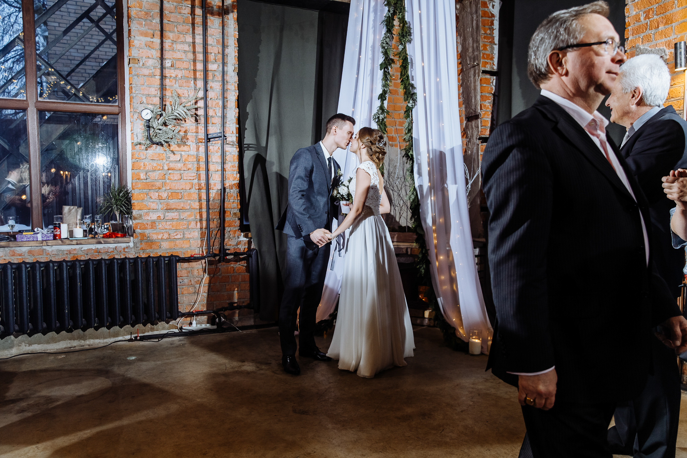 Couple’s kiss in urban venue, by Tanya Bogdan, Bude, Cornwall wedding photographer.  